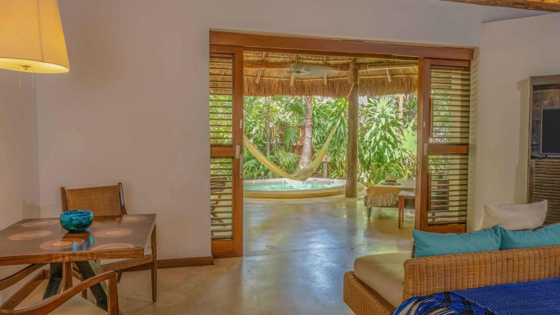 Luxury villa living area opening to a terrace and plunge pool at Viceroy Riviera Maya.
