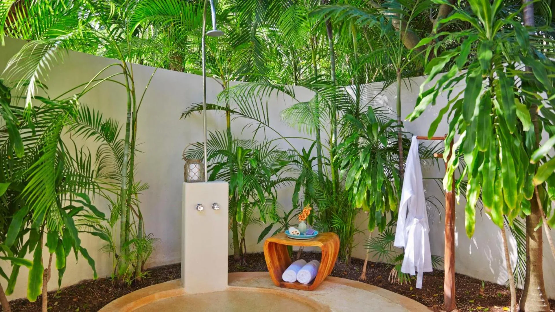 Outdoor villa shower surrounded by palms at Viceroy Riviera Maya.