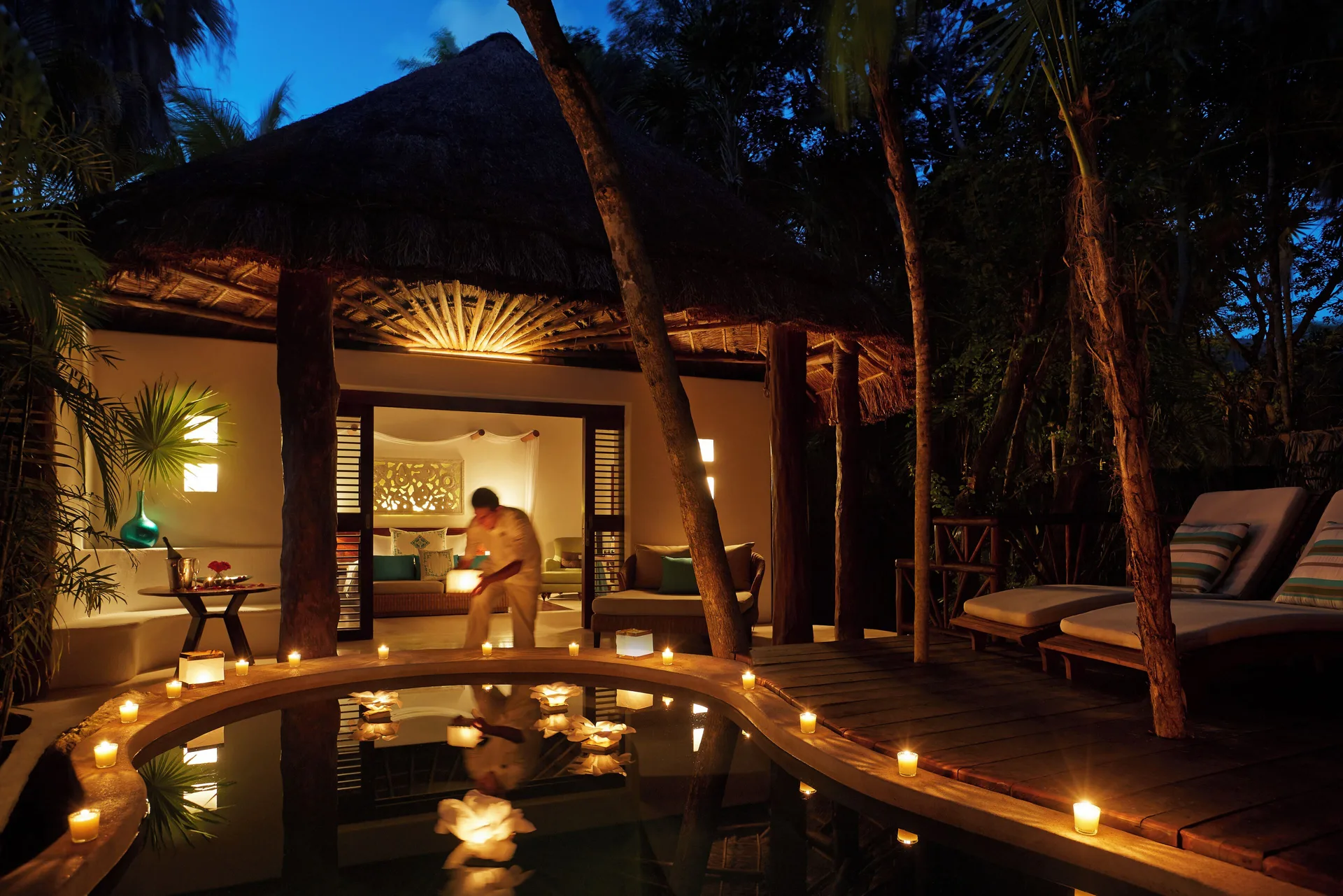Royal Villa plunge pool and deck lit by candles at Viceroy Riviera Maya.