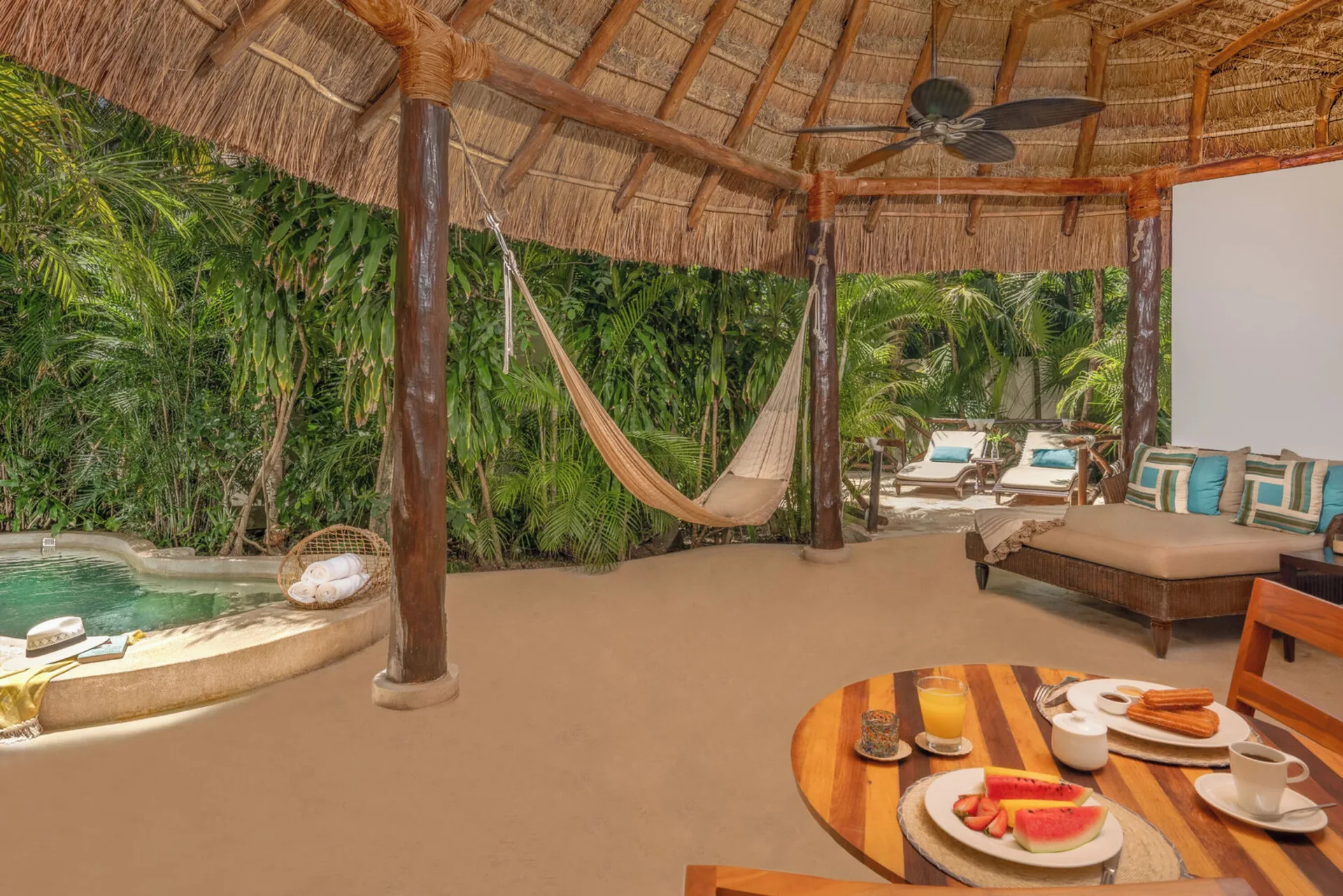 Royal Villa palapa terrace with hammock, breakfast table, and pool at Viceroy Riviera Maya.