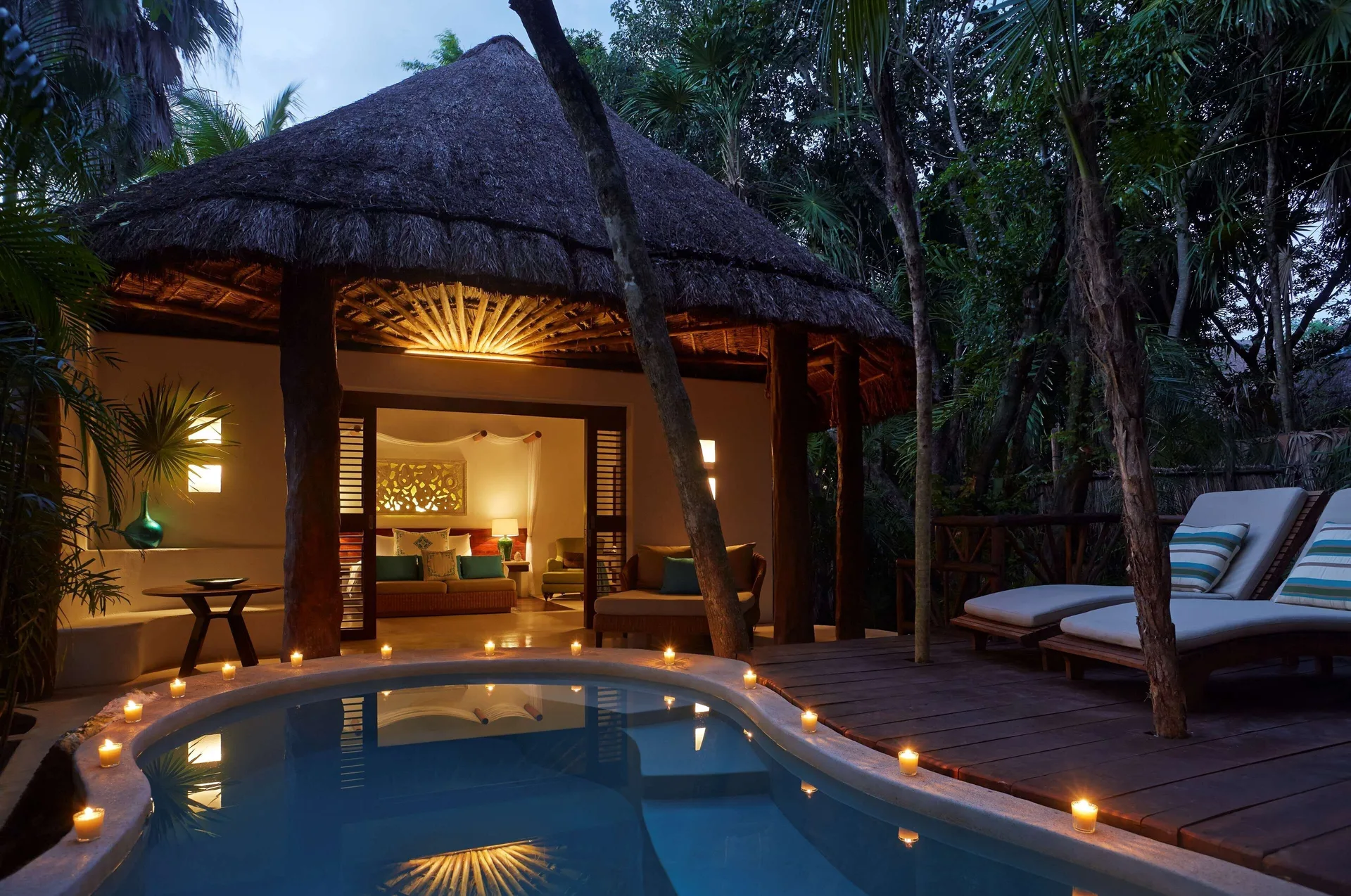 Royal Villa plunge pool and candlelit deck at Viceroy Riviera Maya with the bedroom visible inside.