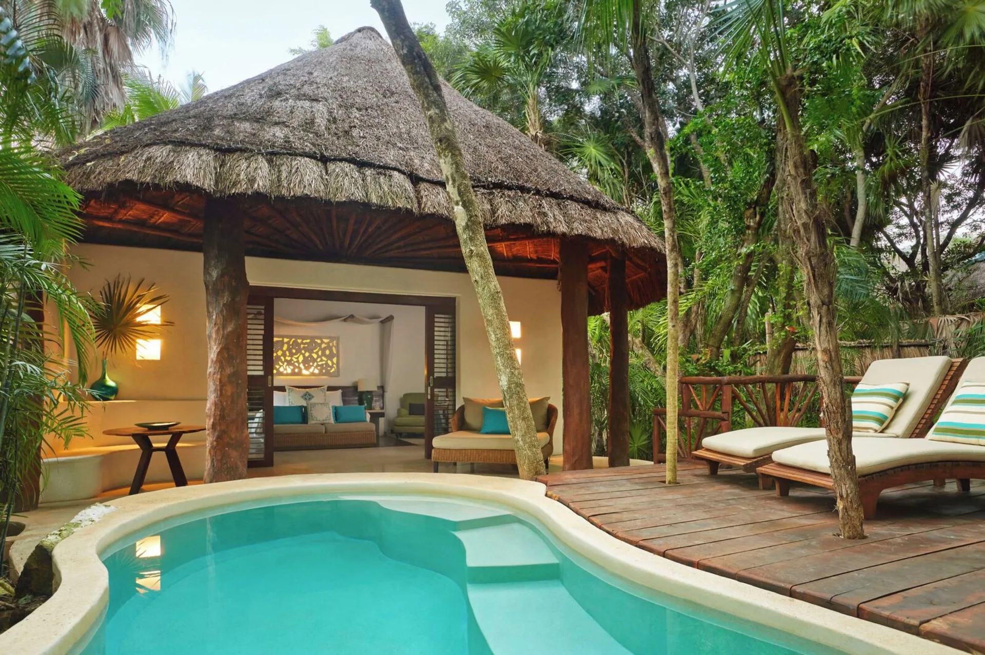 Royal Villa private plunge pool and wooden deck at Viceroy Riviera Maya with lounge chairs and bedroom view.