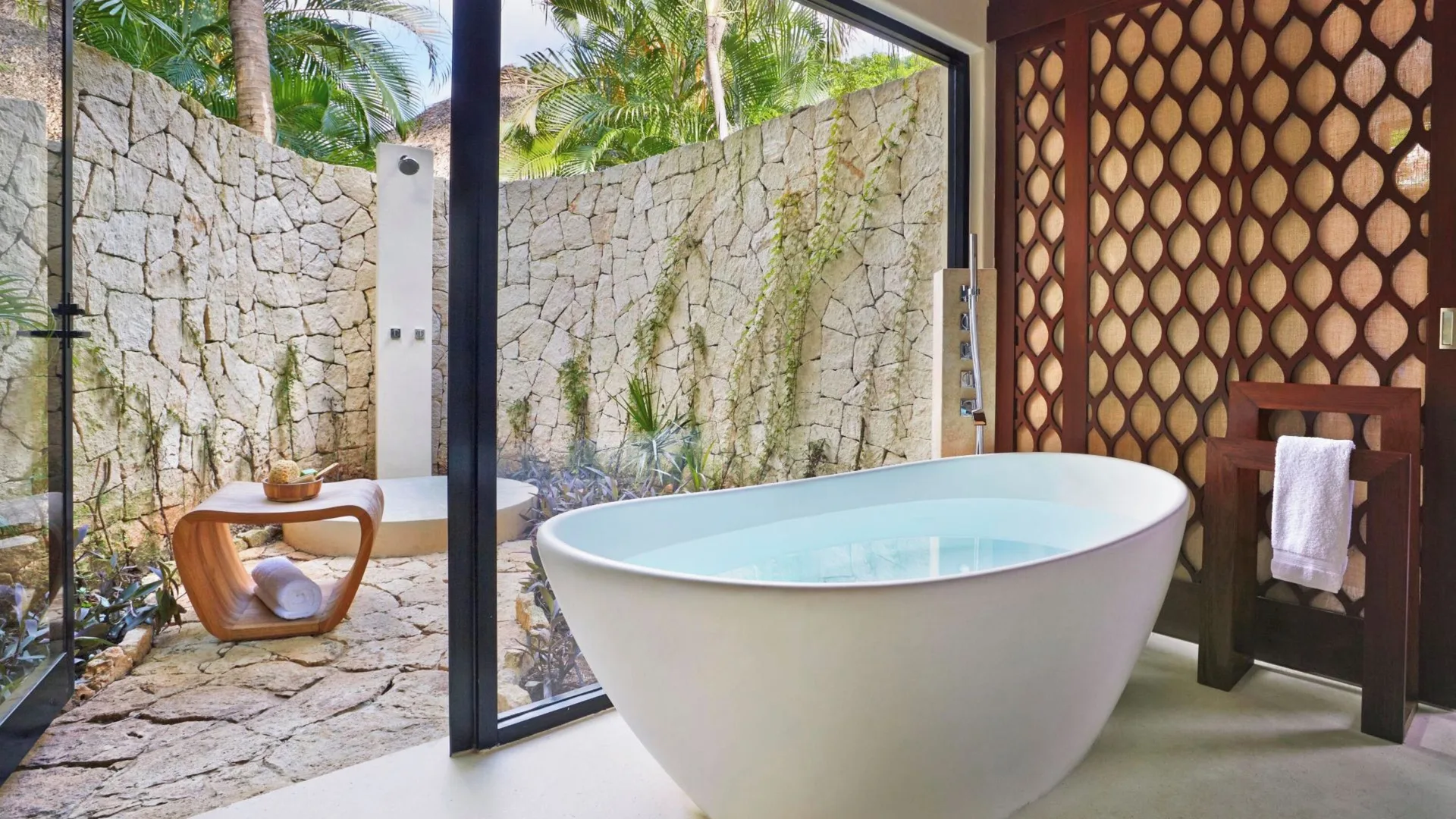 Signature Villa bathroom with soaking tub and outdoor shower at Viceroy Riviera Maya.