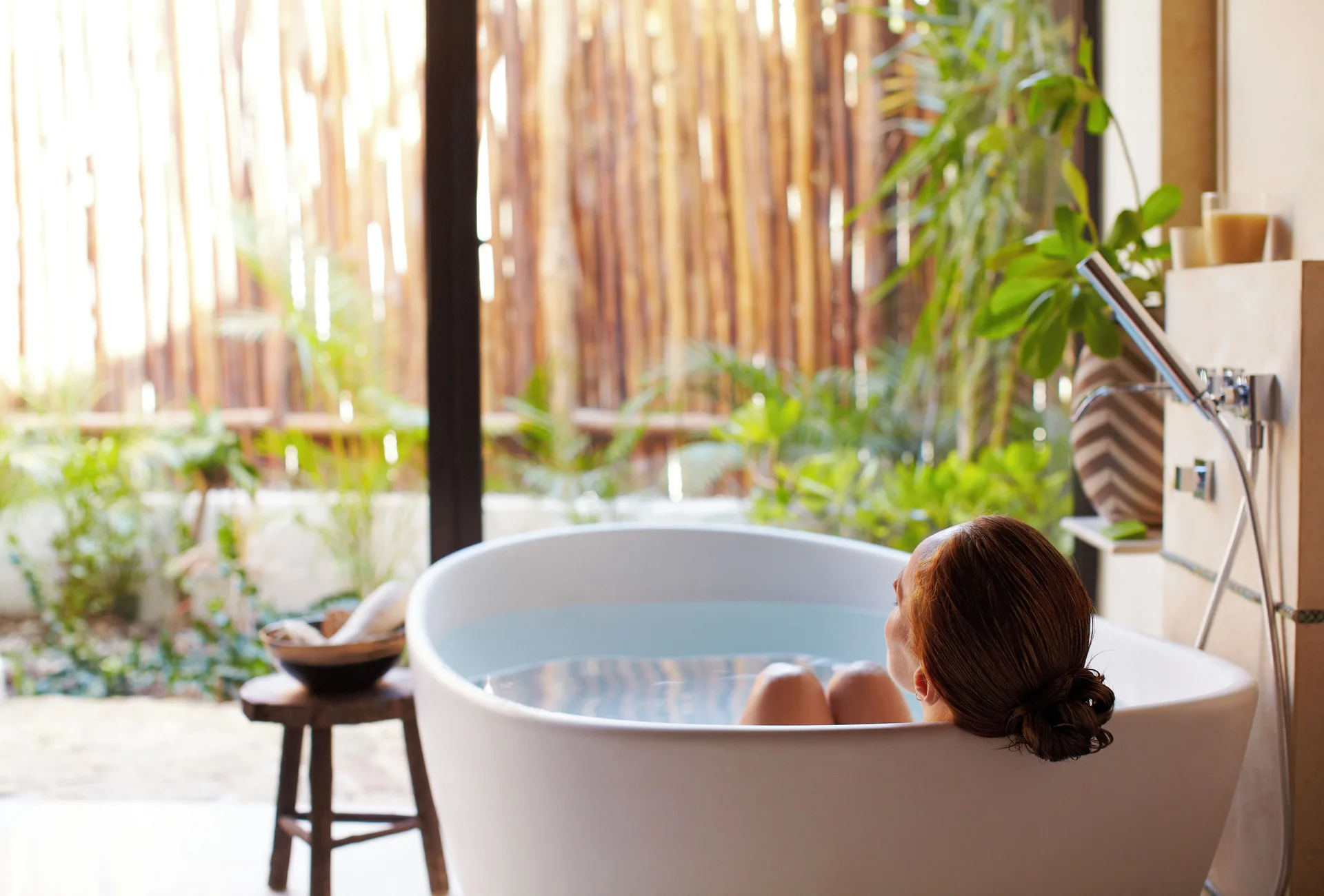 Guest soaking in the Signature Villa tub at Viceroy Riviera Maya.