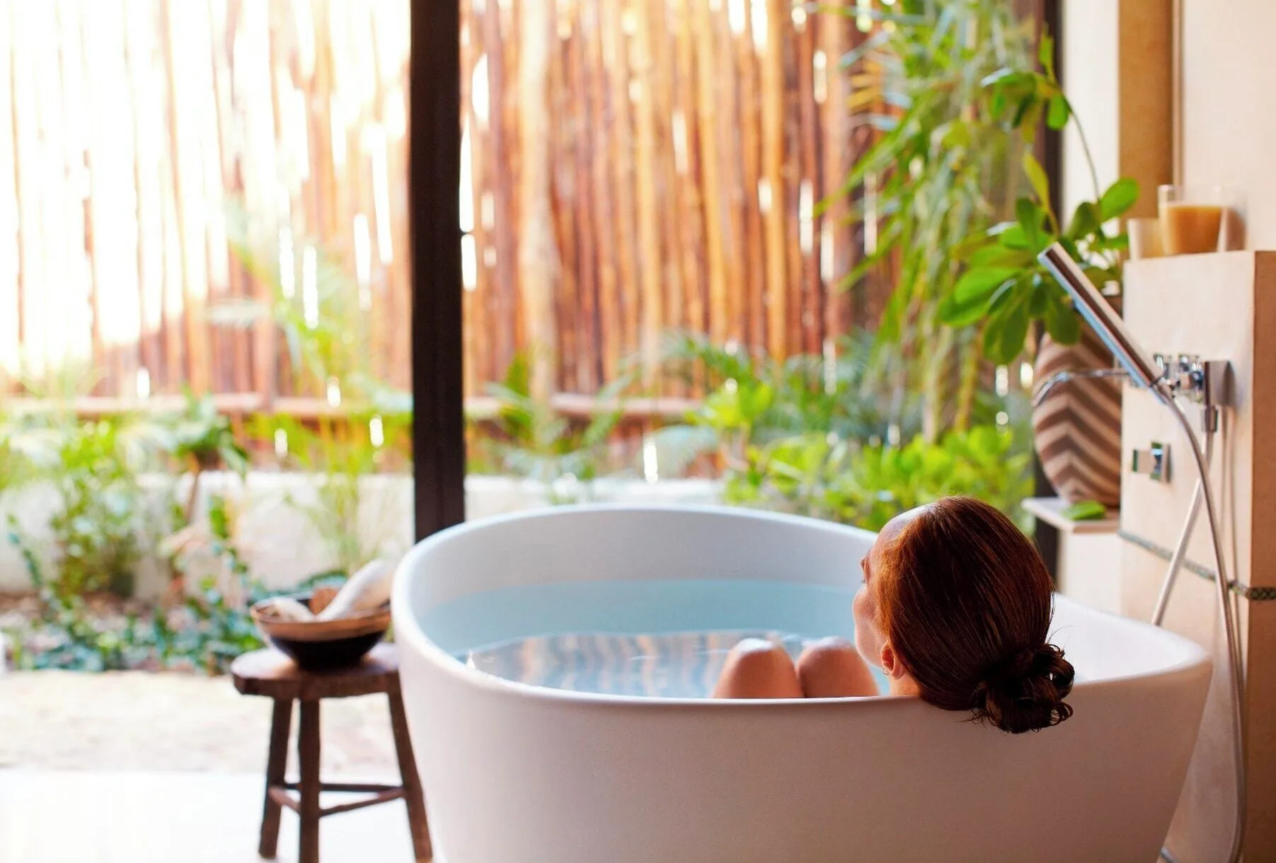 Signature Villa soaking tub beside garden doors at Viceroy Riviera Maya.