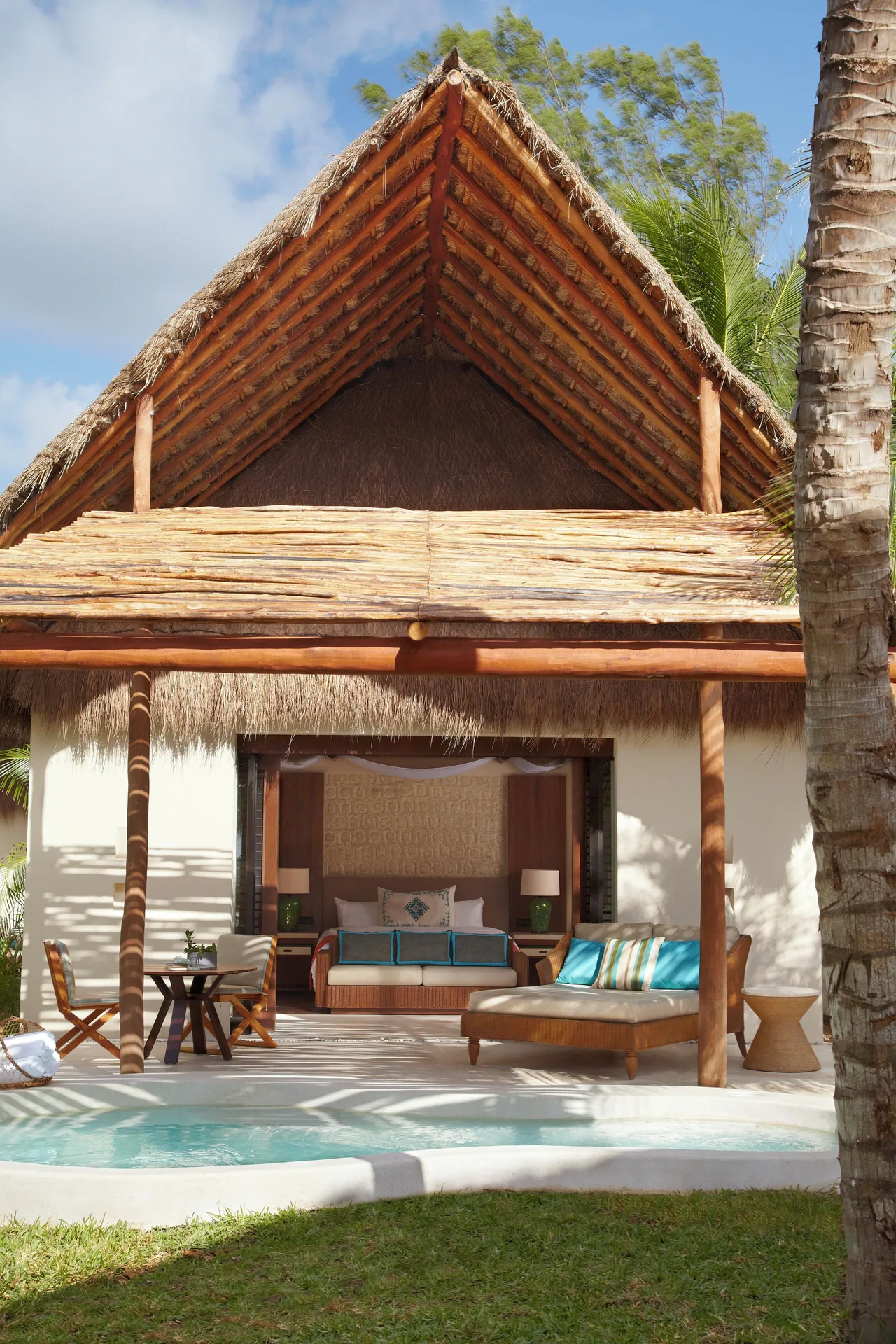 Thatched Viceroy Riviera Maya with plunge pool and bed visible at Viceroy Riviera Maya.
