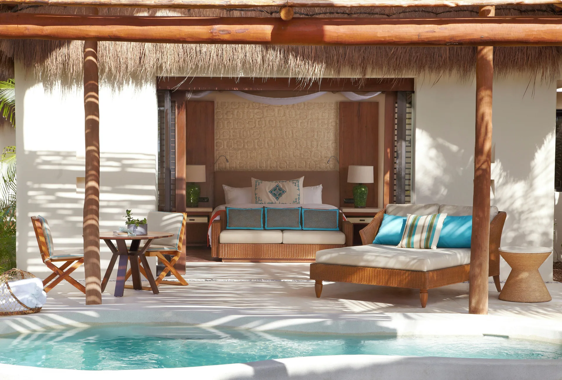 Viceroy Riviera Maya deck with plunge pool, daybed, table, and bed at Viceroy Riviera Maya.