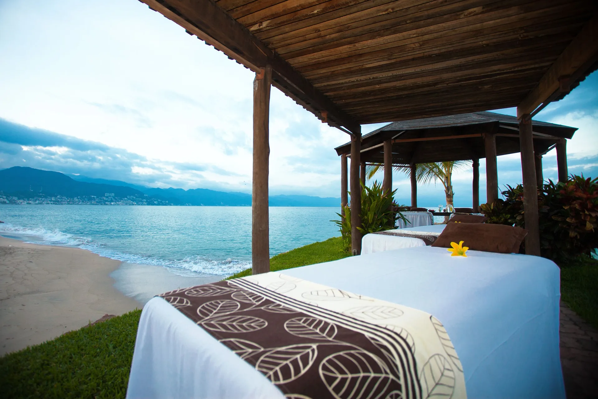 Beachside spa table under a wooden canopy at Villa del Palmar Beach Resort and Spa, Puerto Vallarta.