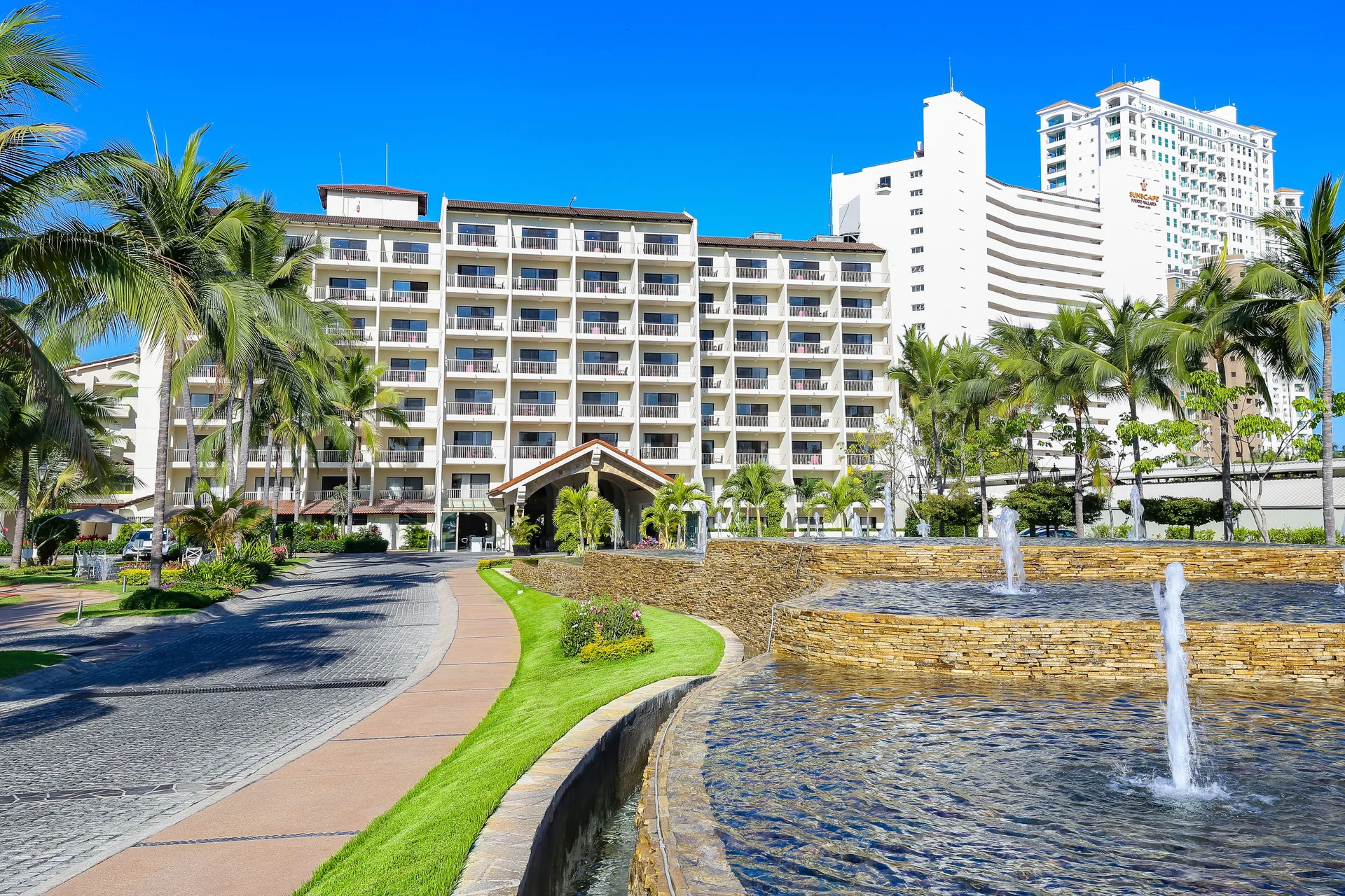 Exterior approach with fountains at Villa del Palmar Beach Resort and Spa, Puerto Vallarta.
