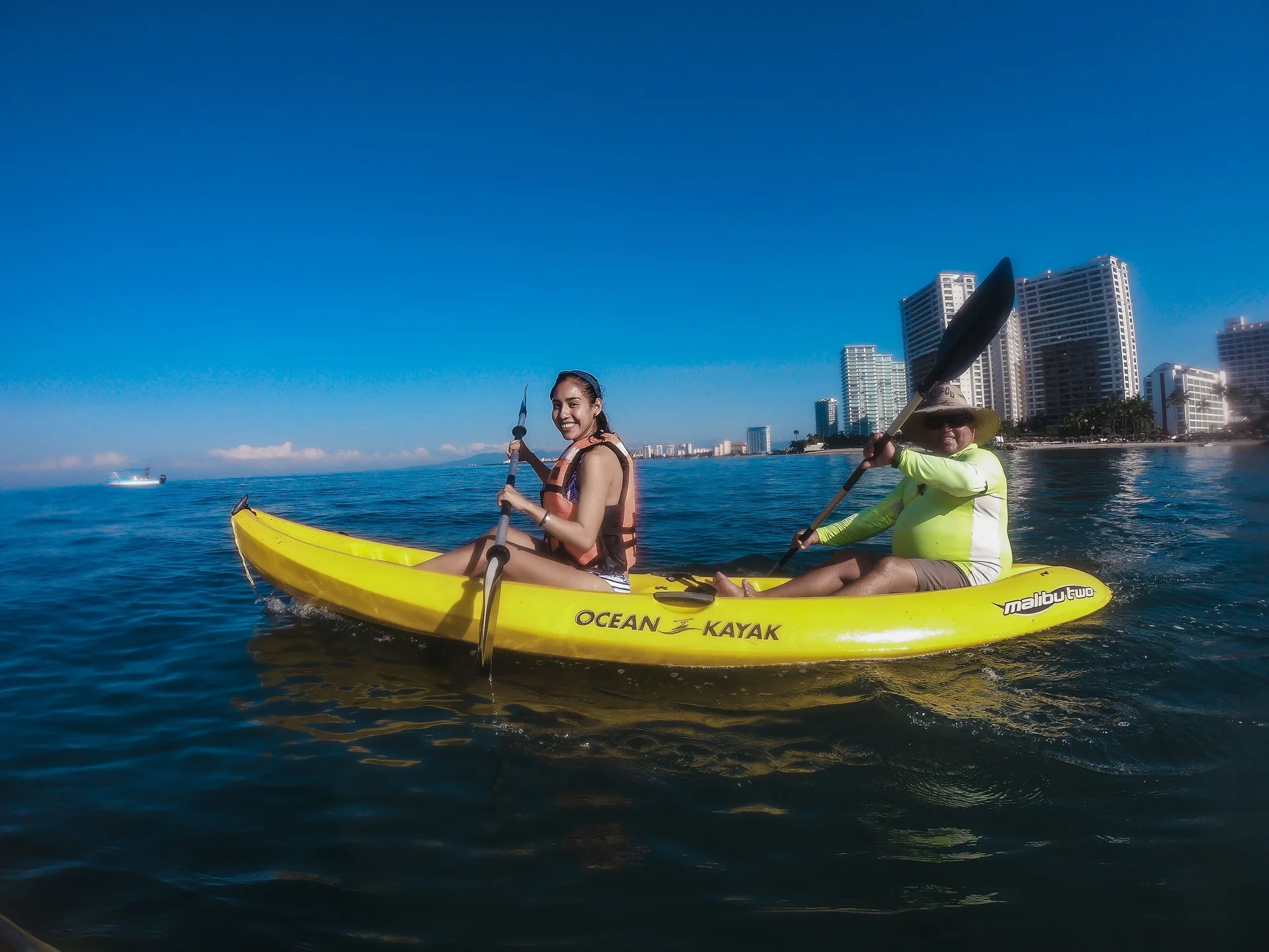 Two guests paddle a yellow kayak offshore at Villa del Palmar Beach Resort and Spa, Puerto Vallarta.