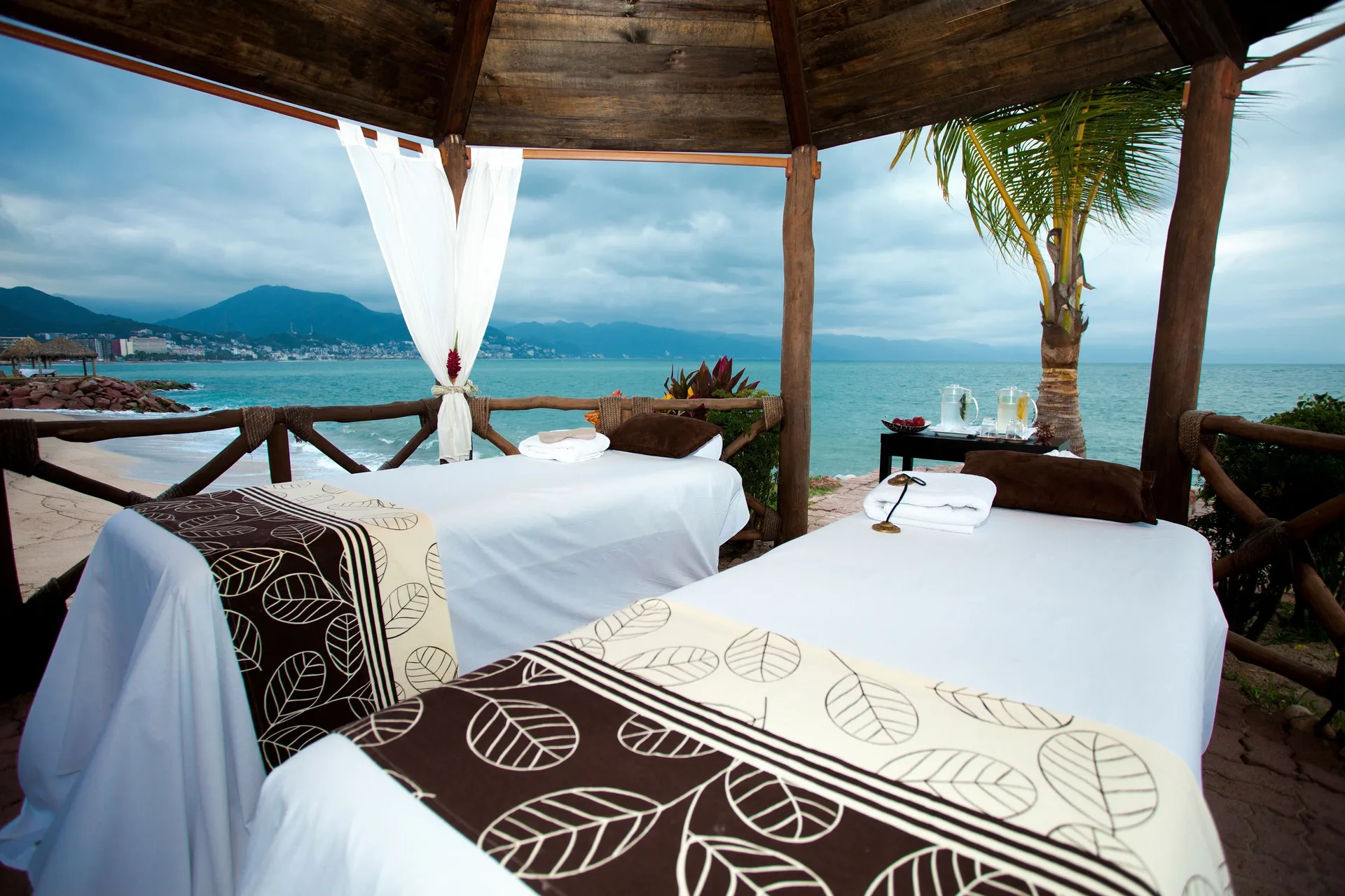 Couples massage setup in an oceanfront gazebo at Villa del Palmar Beach Resort and Spa, Puerto Vallarta.