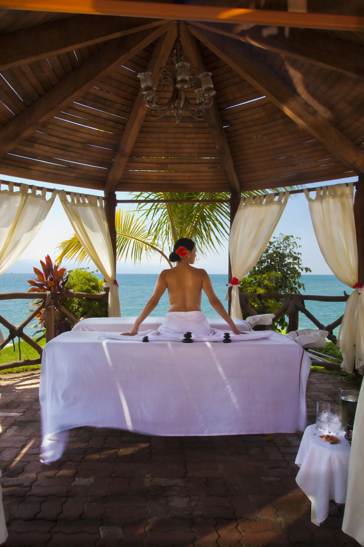 Oceanfront massage table under a wooden gazebo at Villa del Palmar Beach Resort and Spa, Puerto Vallarta.