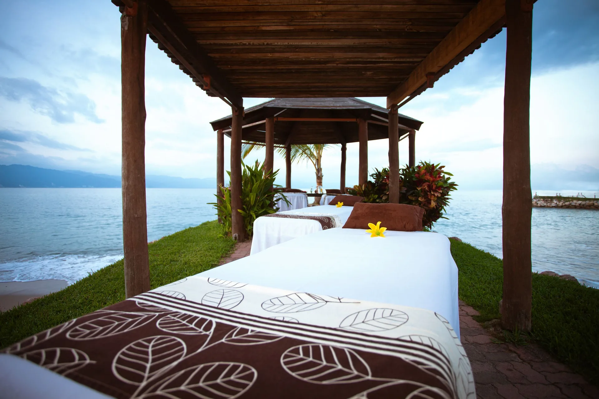 Row of outdoor spa tables by the shoreline at Villa del Palmar Beach Resort and Spa, Puerto Vallarta.