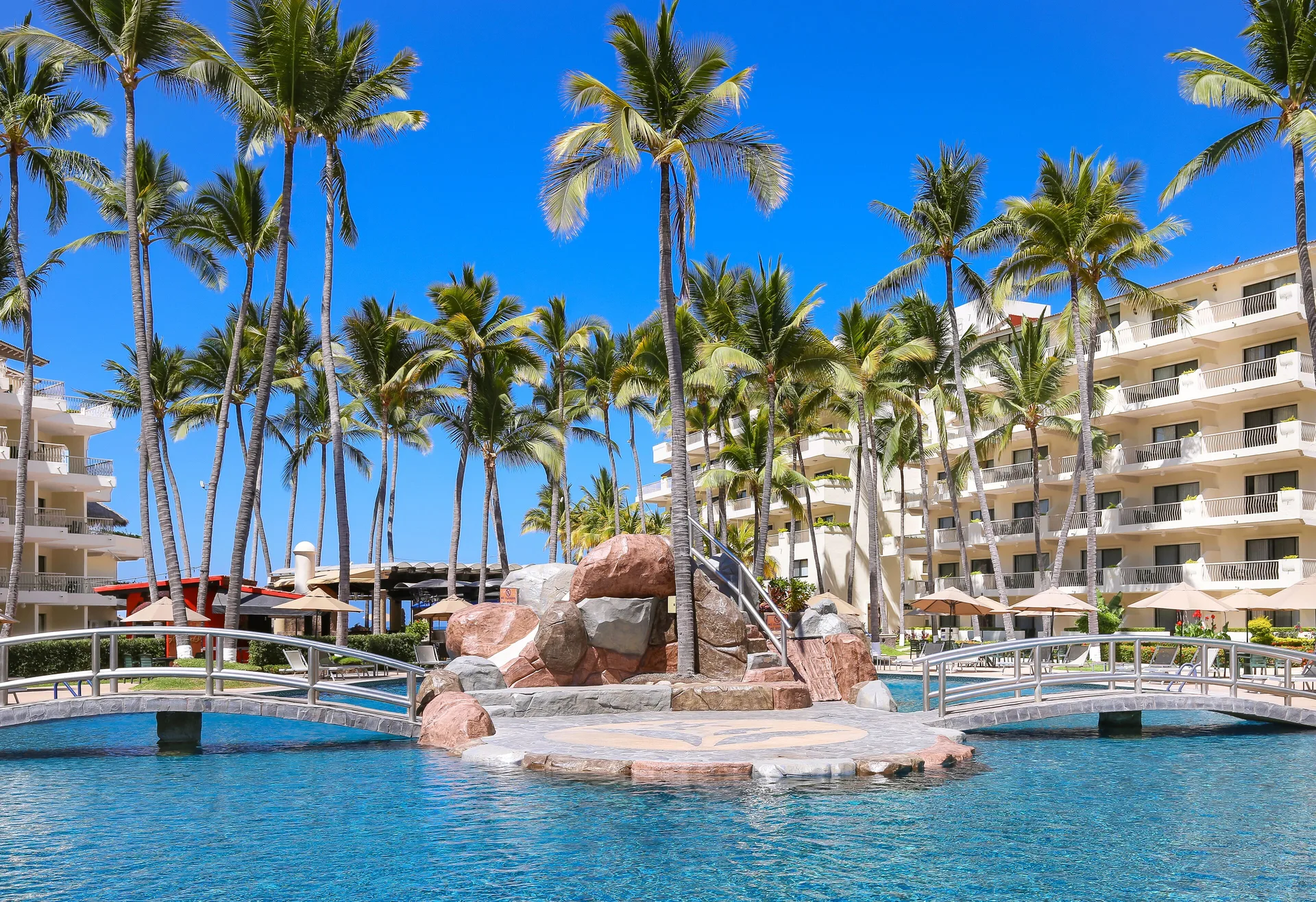 Palm-lined pool bridges at Villa del Palmar Beach Resort and Spa, Puerto Vallarta.