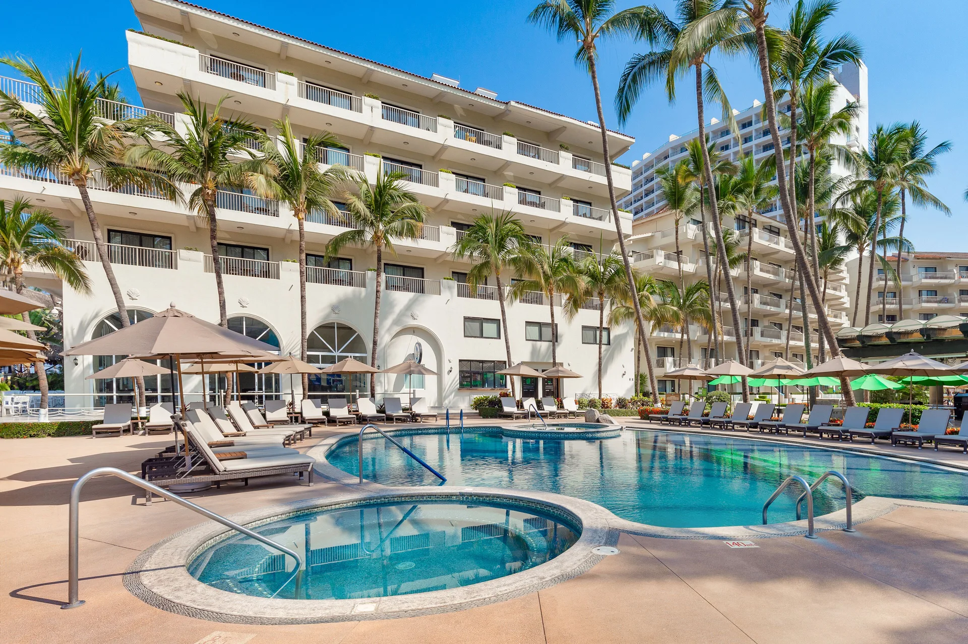 Pool and hot tub beside guest room buildings at Villa del Palmar Beach Resort and Spa, Puerto Vallarta.