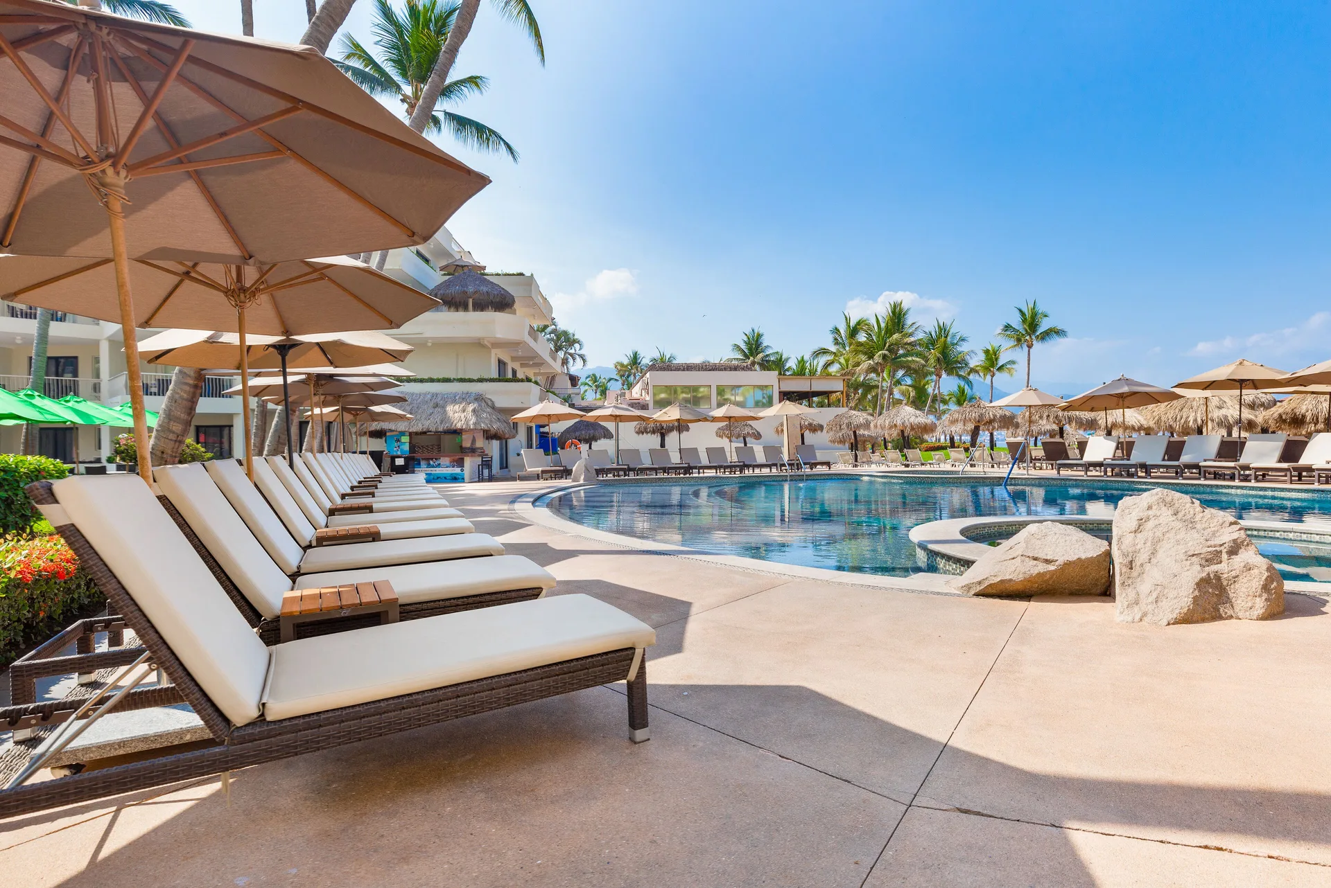 Poolside loungers and umbrellas at Villa del Palmar Beach Resort and Spa, Puerto Vallarta.