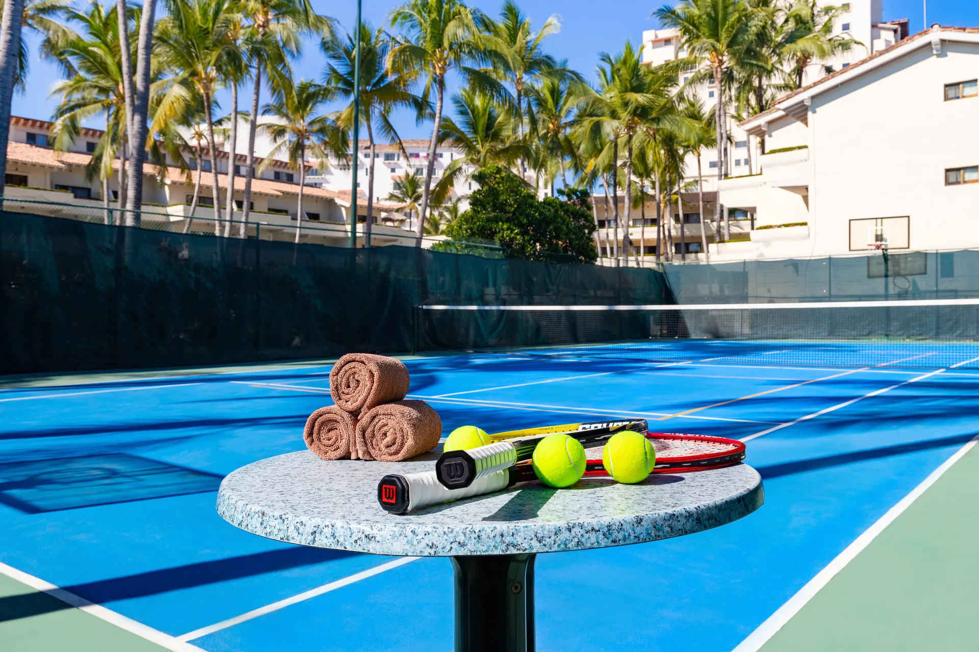 Tennis rackets, balls and towels on a court at Villa del Palmar Beach Resort and Spa, Puerto Vallarta.