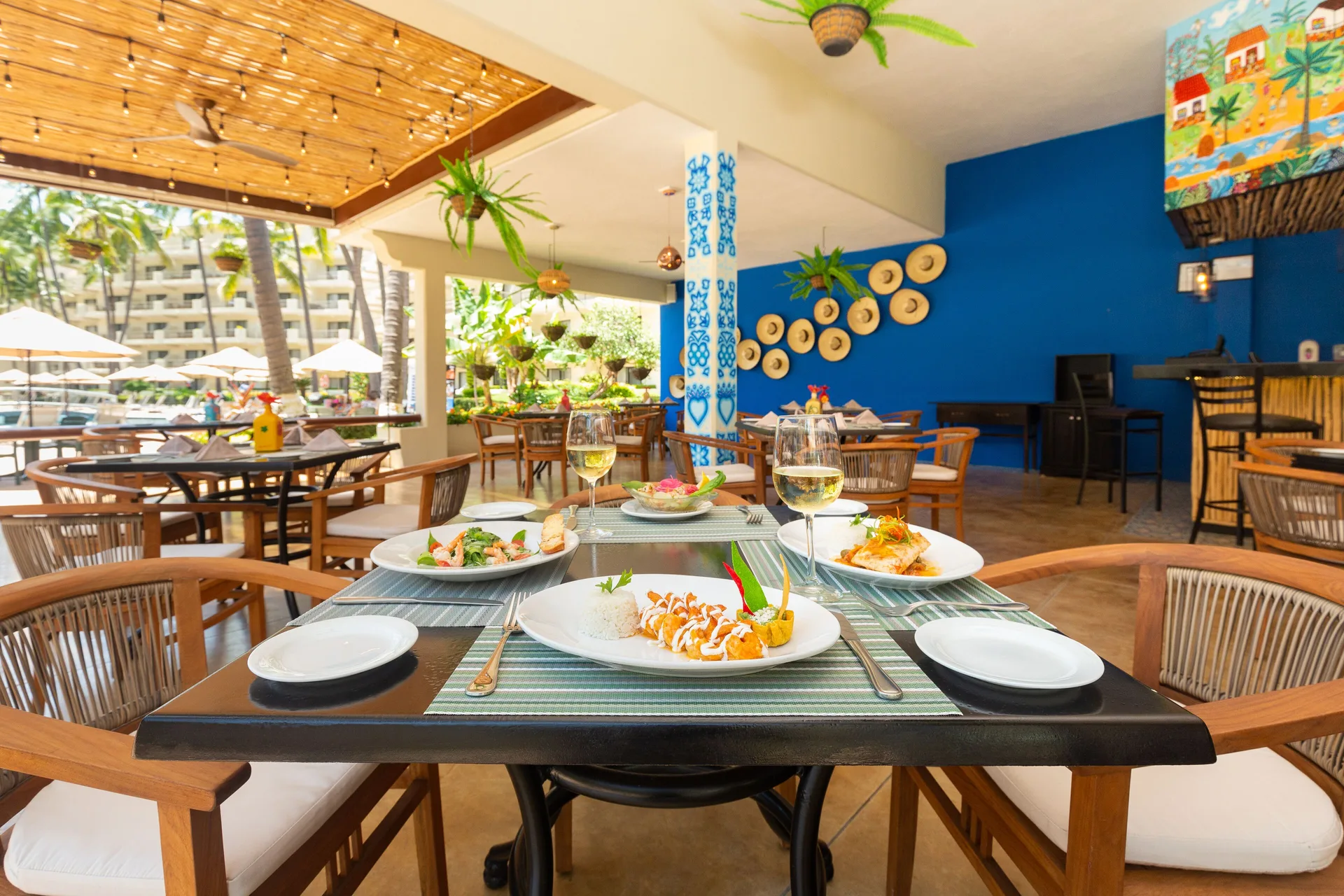 El Patron dining table with plated dishes at Villa del Palmar Beach Resort and Spa, Puerto Vallarta.