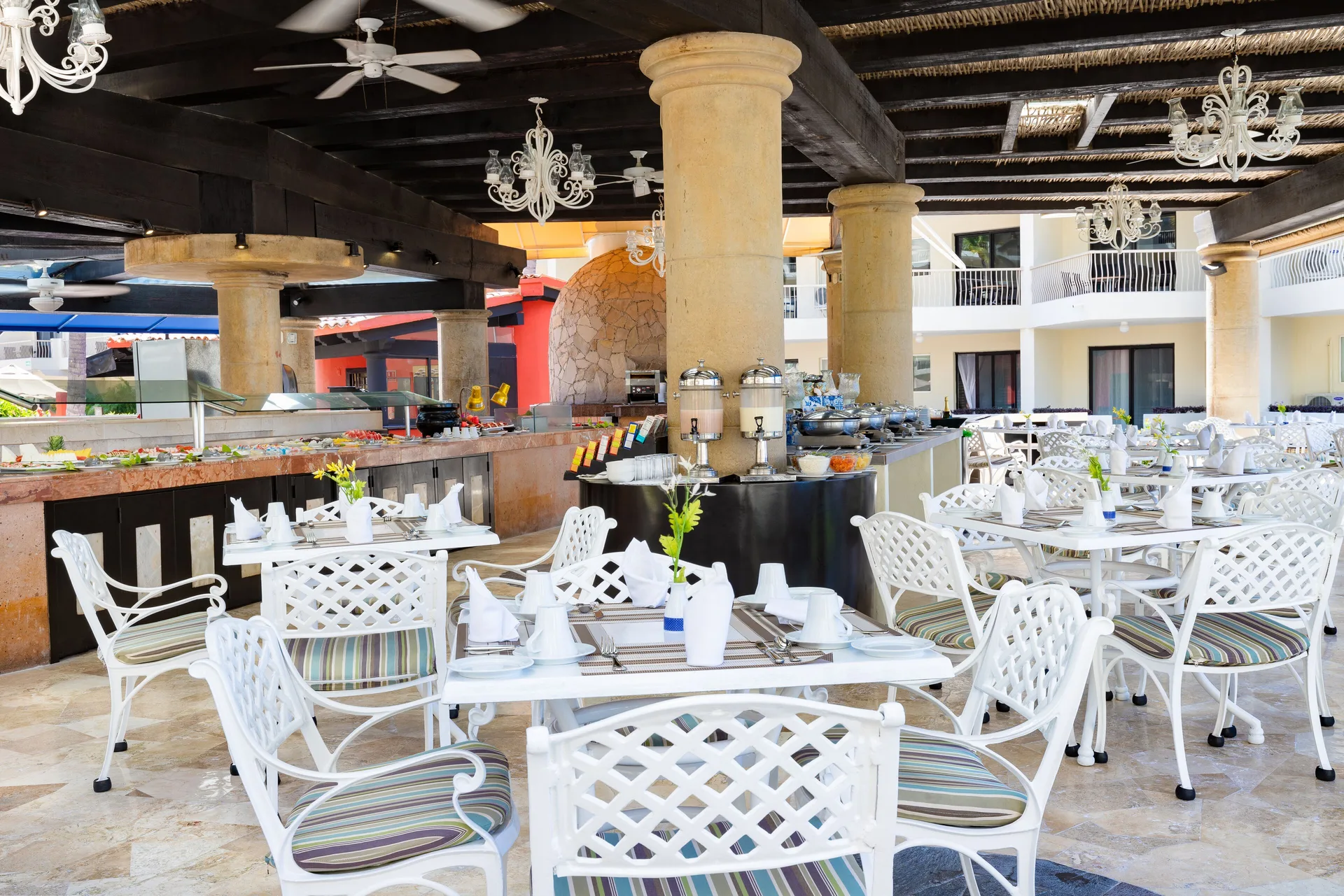 Open-air buffet dining room with white chairs at Villa del Palmar Beach Resort and Spa, Puerto Vallarta.