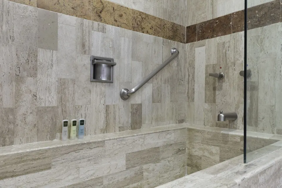 Junior Suite tub and shower with stone tile at Villa del Palmar Beach Resort and Spa, Puerto Vallarta.