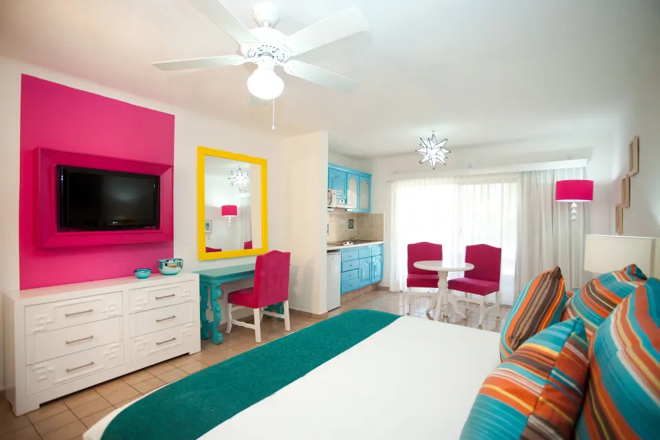 Junior Suite with king bed, kitchenette, vanity, and sitting area at Villa del Palmar Beach Resort and Spa, Puerto Vallarta.