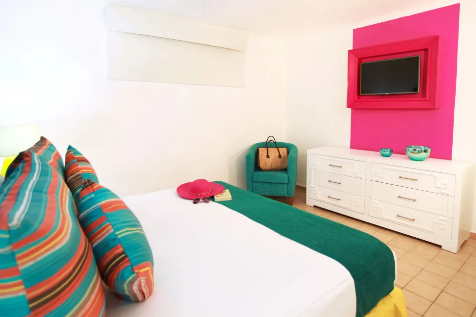 Superior One Bedroom Suite bed and dresser at Villa del Palmar Beach Resort and Spa, Puerto Vallarta.