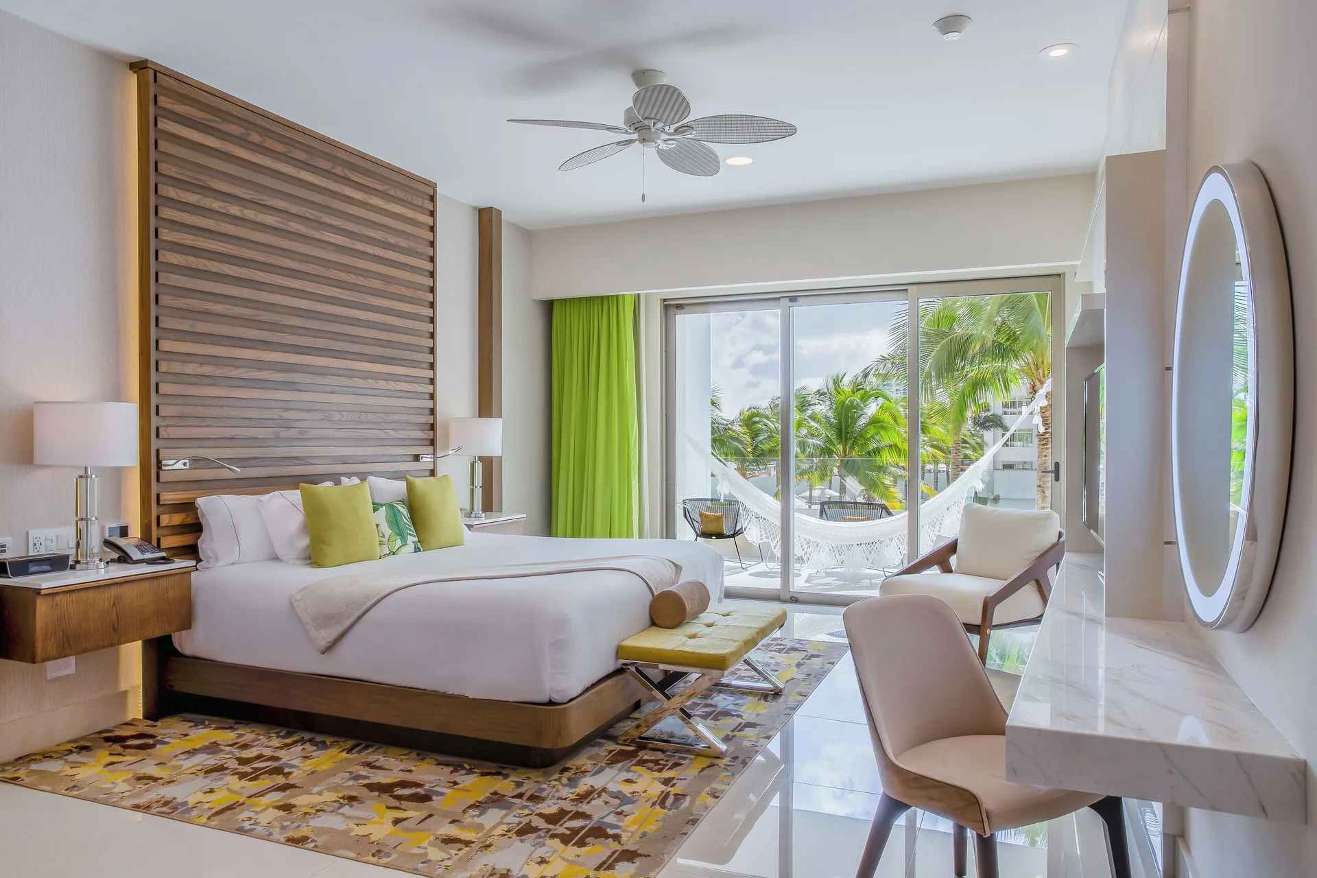 King bed guest room with balcony hammock at Villa del Palmar Cancun Beach Resort & Spa.