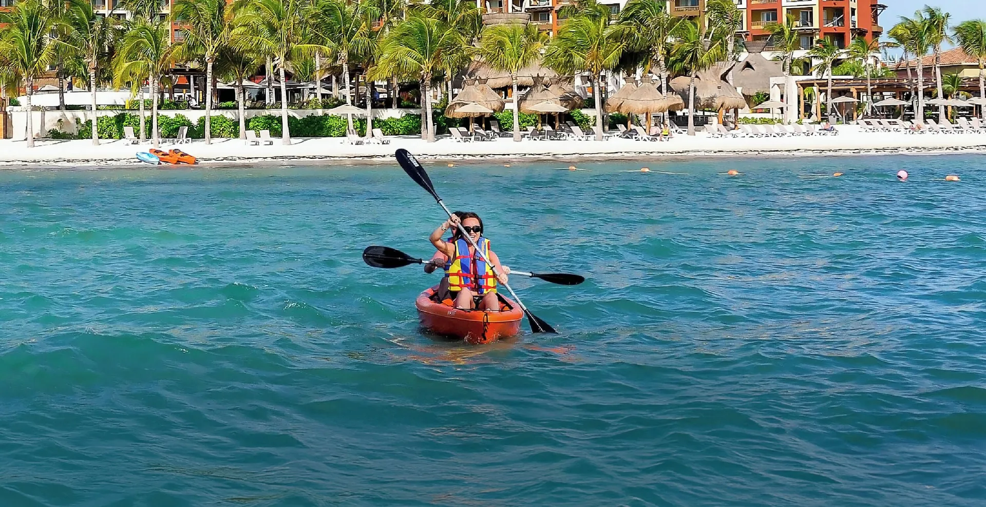 Two guests kayaking offshore at Villa del Palmar Cancun Beach Resort & Spa.