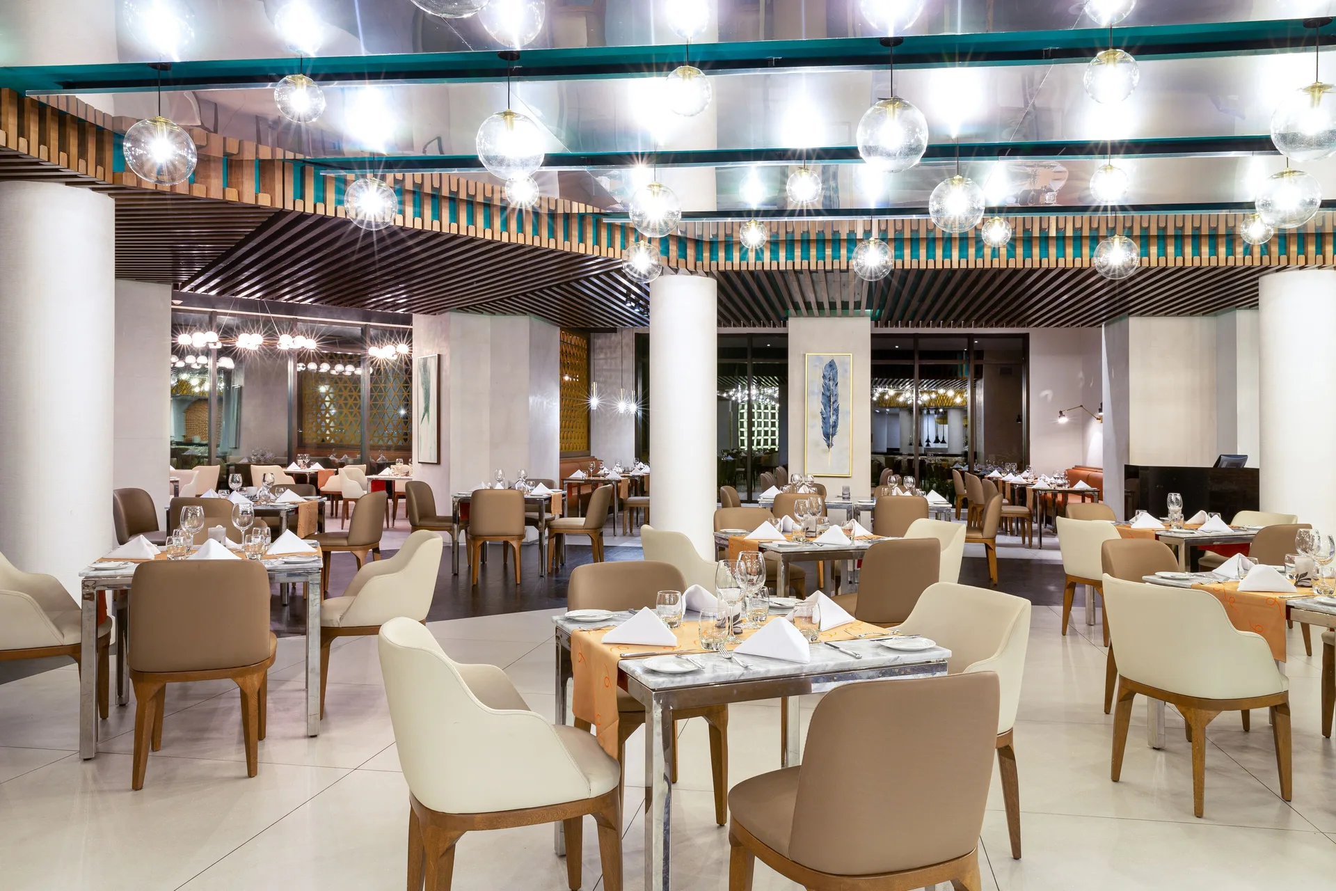 Modern restaurant dining room with globe lights at Villa del Palmar Cancun Beach Resort & Spa.