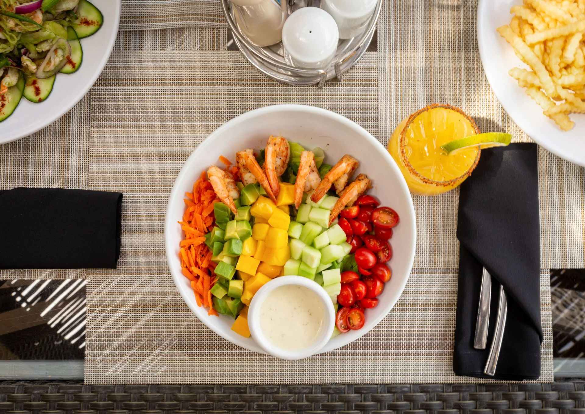 Shrimp salad bowl with fries and a citrus drink at Villa del Palmar Cancun Beach Resort & Spa.