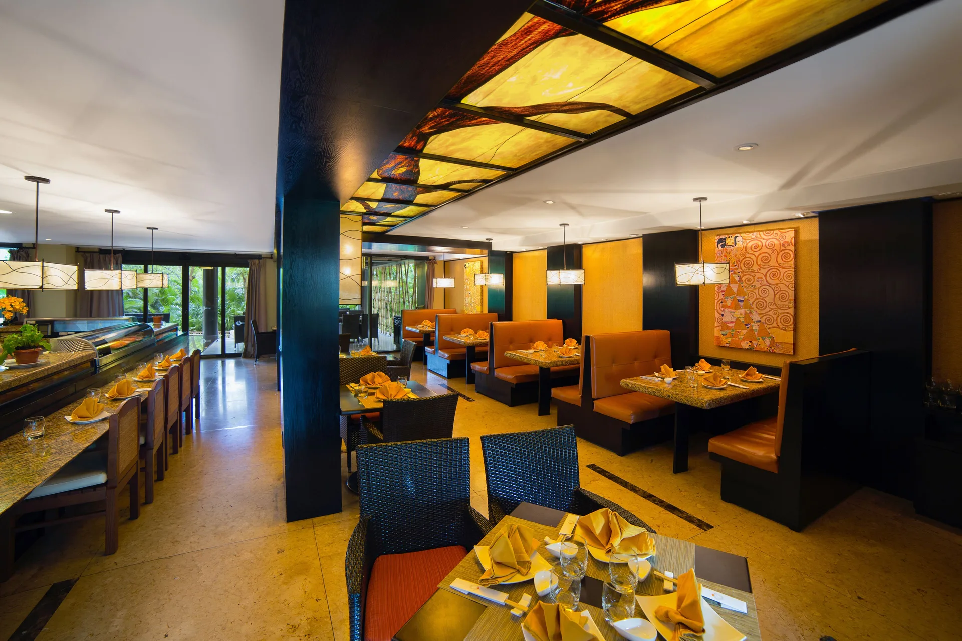 Warm restaurant dining room with booths at Villa del Palmar Cancun Beach Resort & Spa.