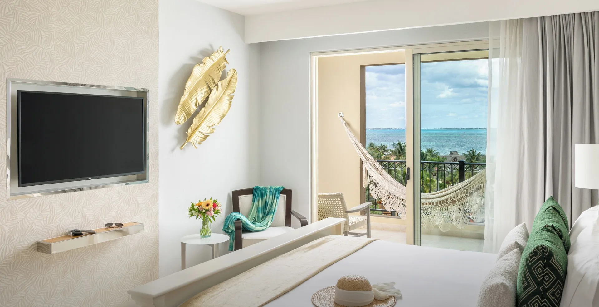 Deluxe room king bed with ocean-view balcony at Villa del Palmar Cancun Beach Resort & Spa.