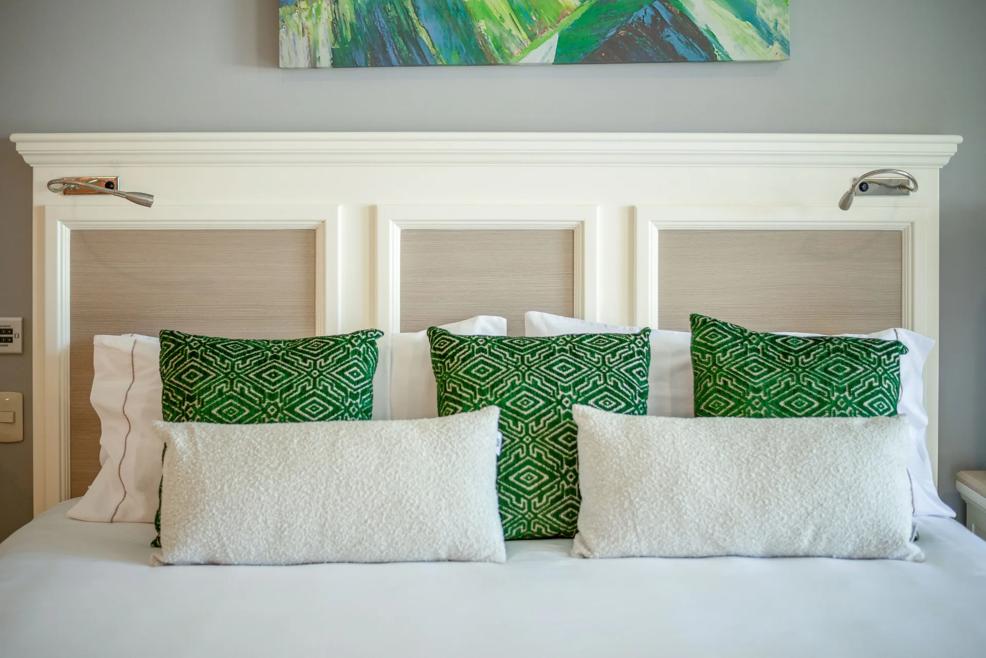 Deluxe room bed with green pillows at Villa del Palmar Cancun Beach Resort & Spa.