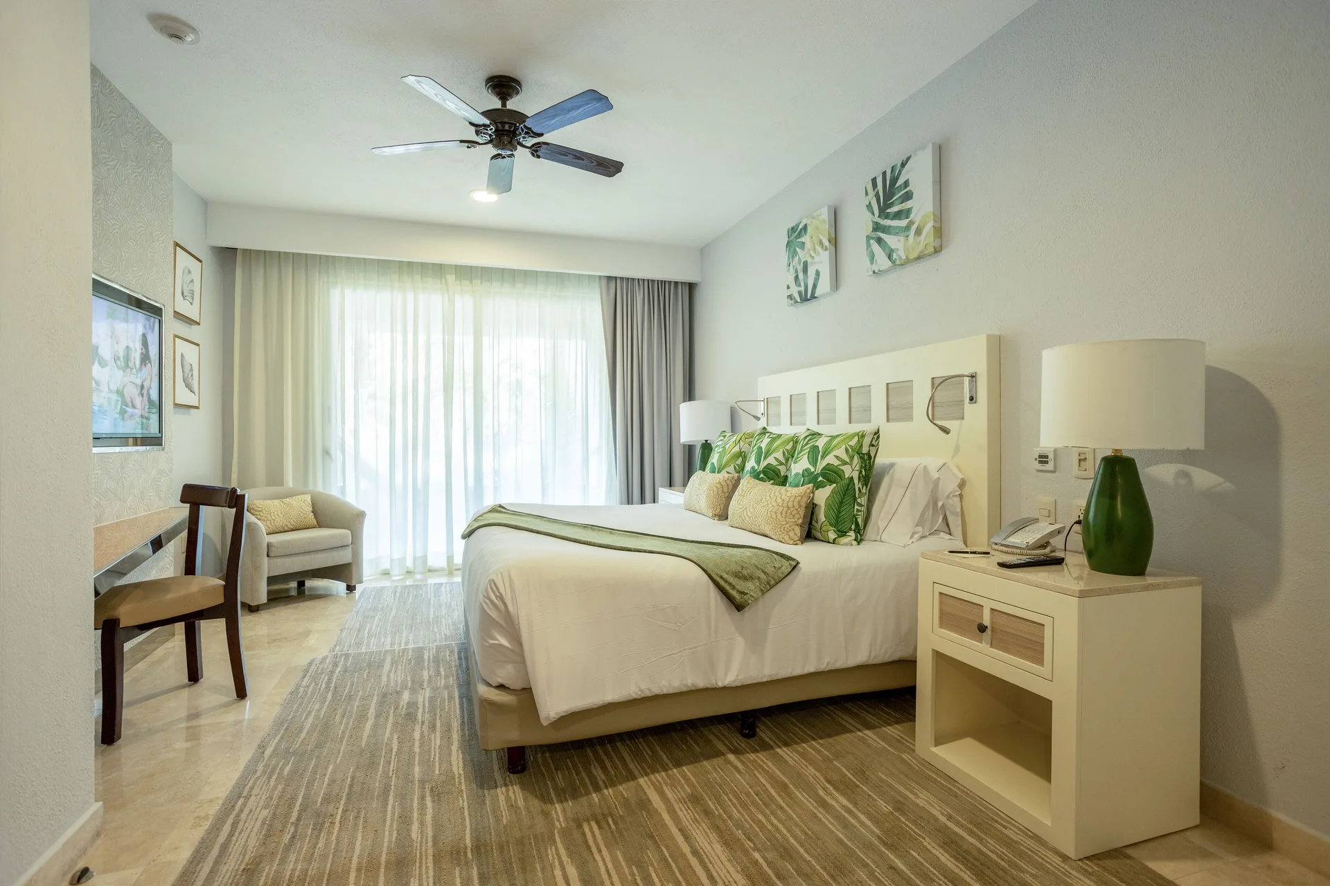 Deluxe room with king bed and seating at Villa del Palmar Cancun Beach Resort & Spa.