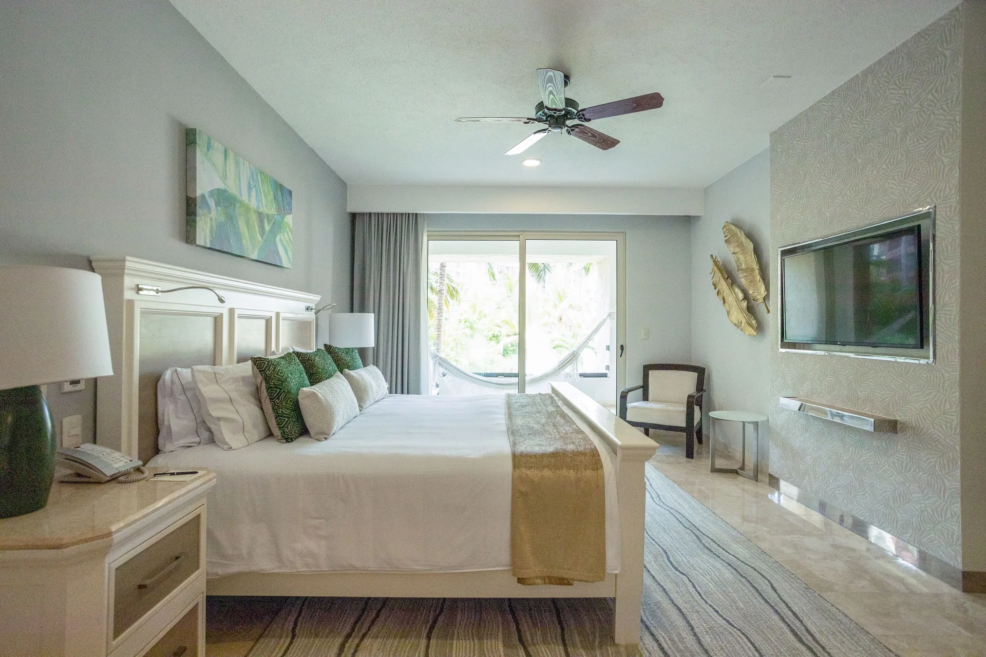 One Bedroom suite with white bed and balcony hammock at Villa del Palmar Cancun Beach Resort & Spa.