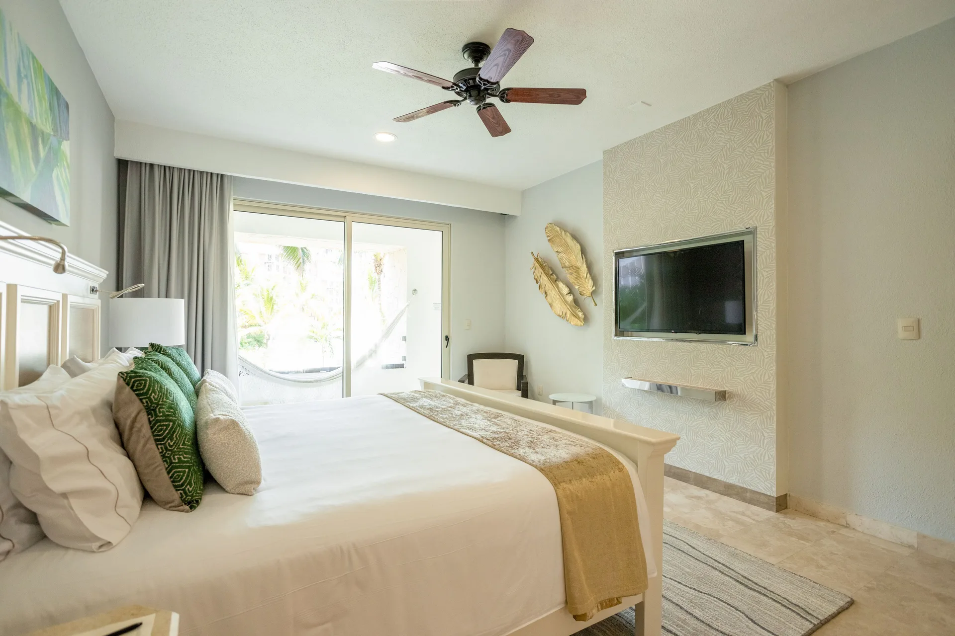 One Bedroom king bed with wall-mounted TV at Villa del Palmar Cancun Beach Resort & Spa.