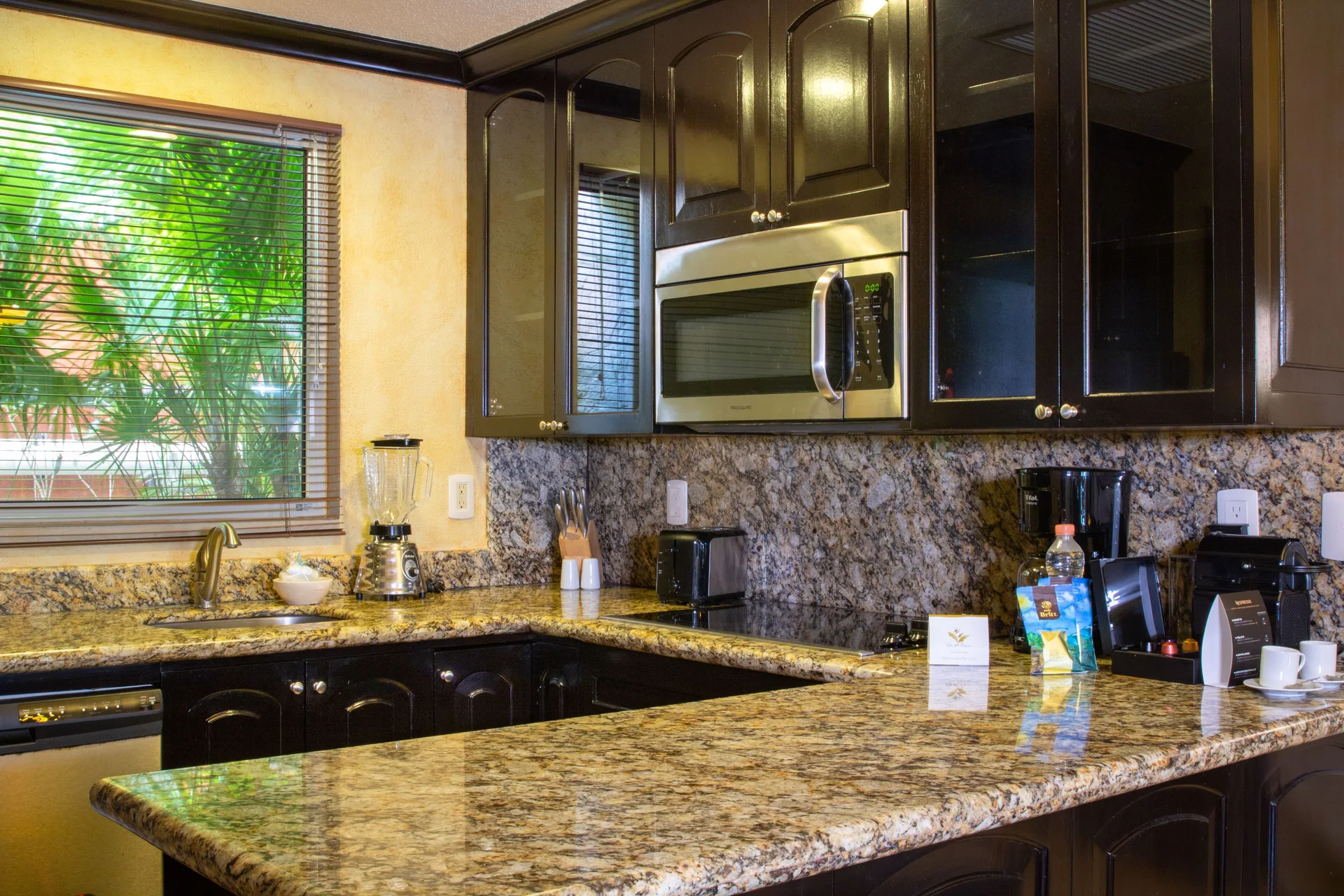 One Bedroom suite kitchen with granite counter at Villa del Palmar Cancun Beach Resort & Spa.