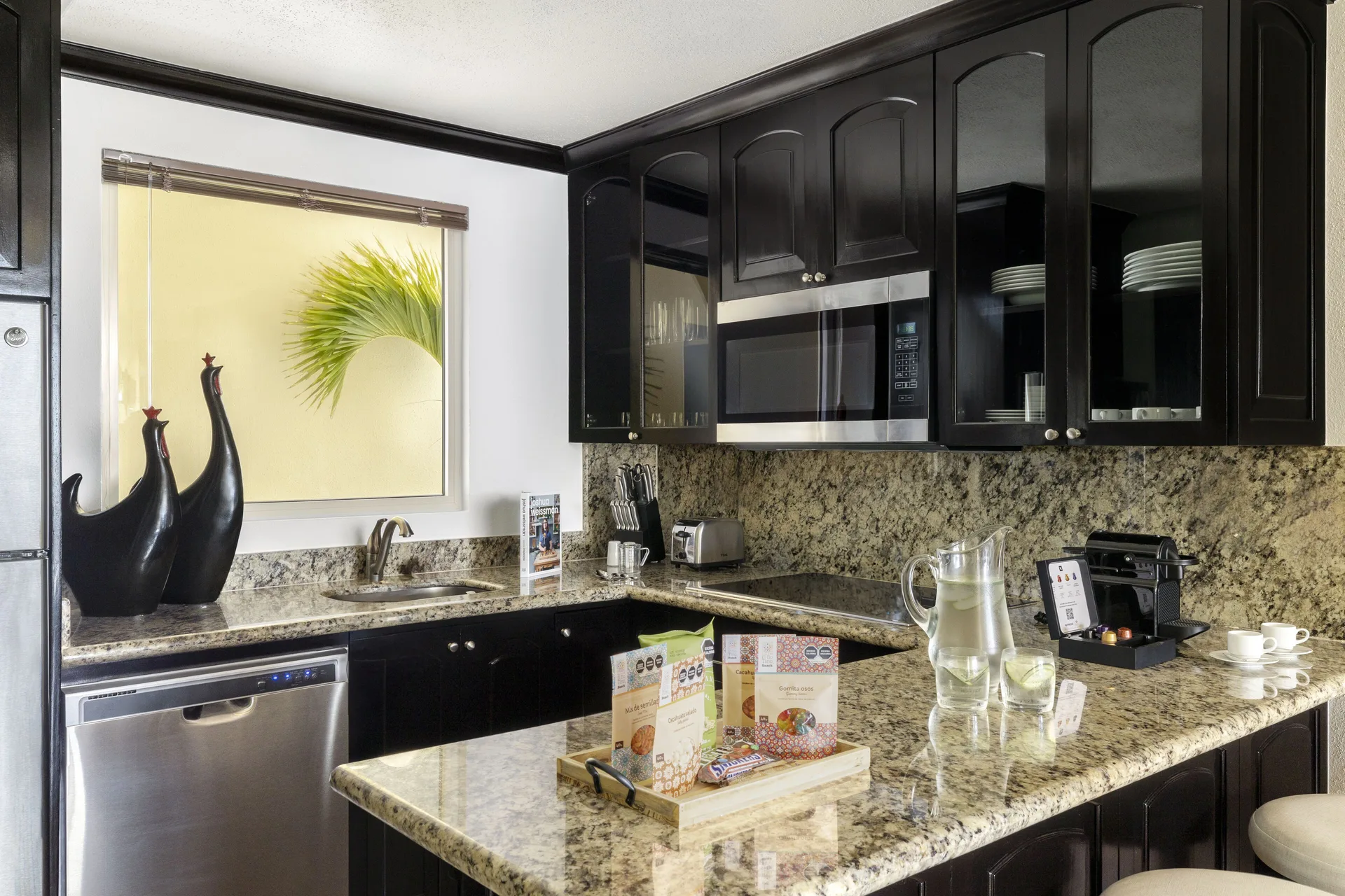 One Bedroom suite kitchen with dishwasher and counter at Villa del Palmar Cancun Beach Resort & Spa.