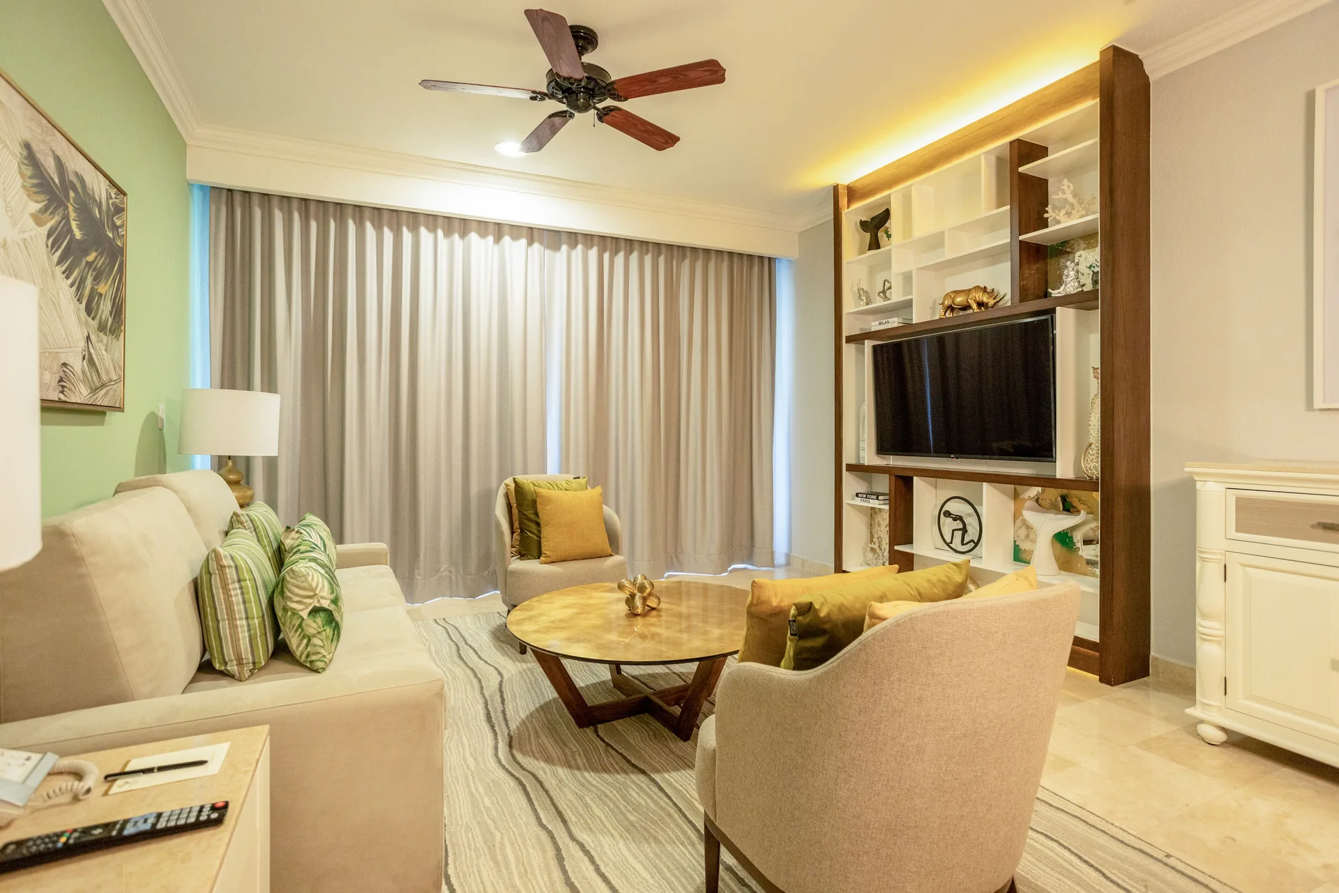 One Bedroom living area with sofa and media wall at Villa del Palmar Cancun Beach Resort & Spa.