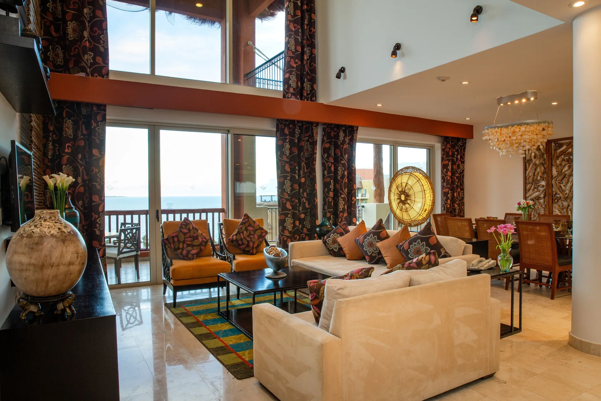 Three Bedroom Loft living room with double-height windows at Villa del Palmar Cancun Beach Resort & Spa.
