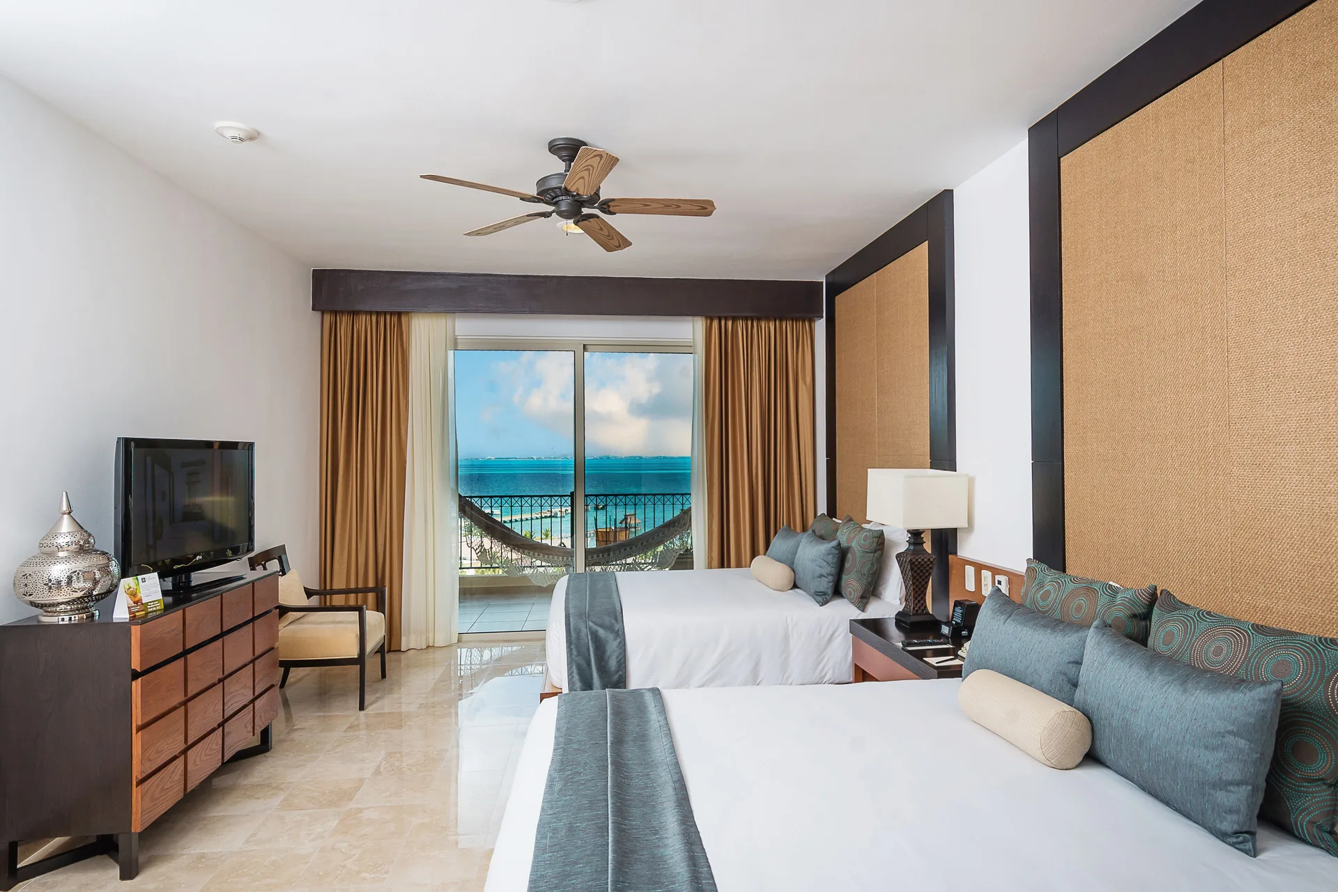 Three Bedroom Loft bedroom with two beds and balcony view at Villa del Palmar Cancun Beach Resort & Spa.
