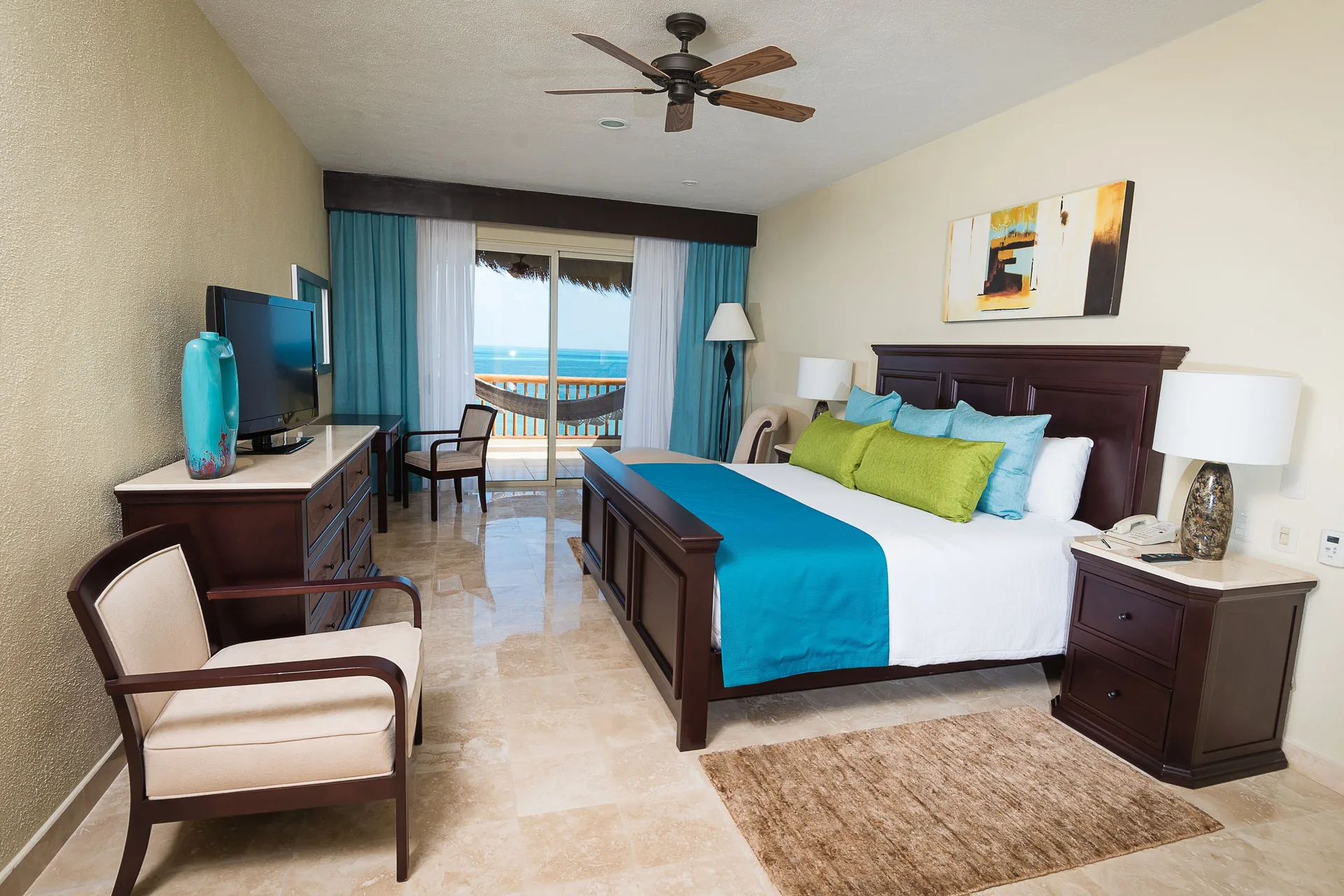 Ocean-front king bedroom with balcony view at Villa del Palmar Cancun Beach Resort & Spa.