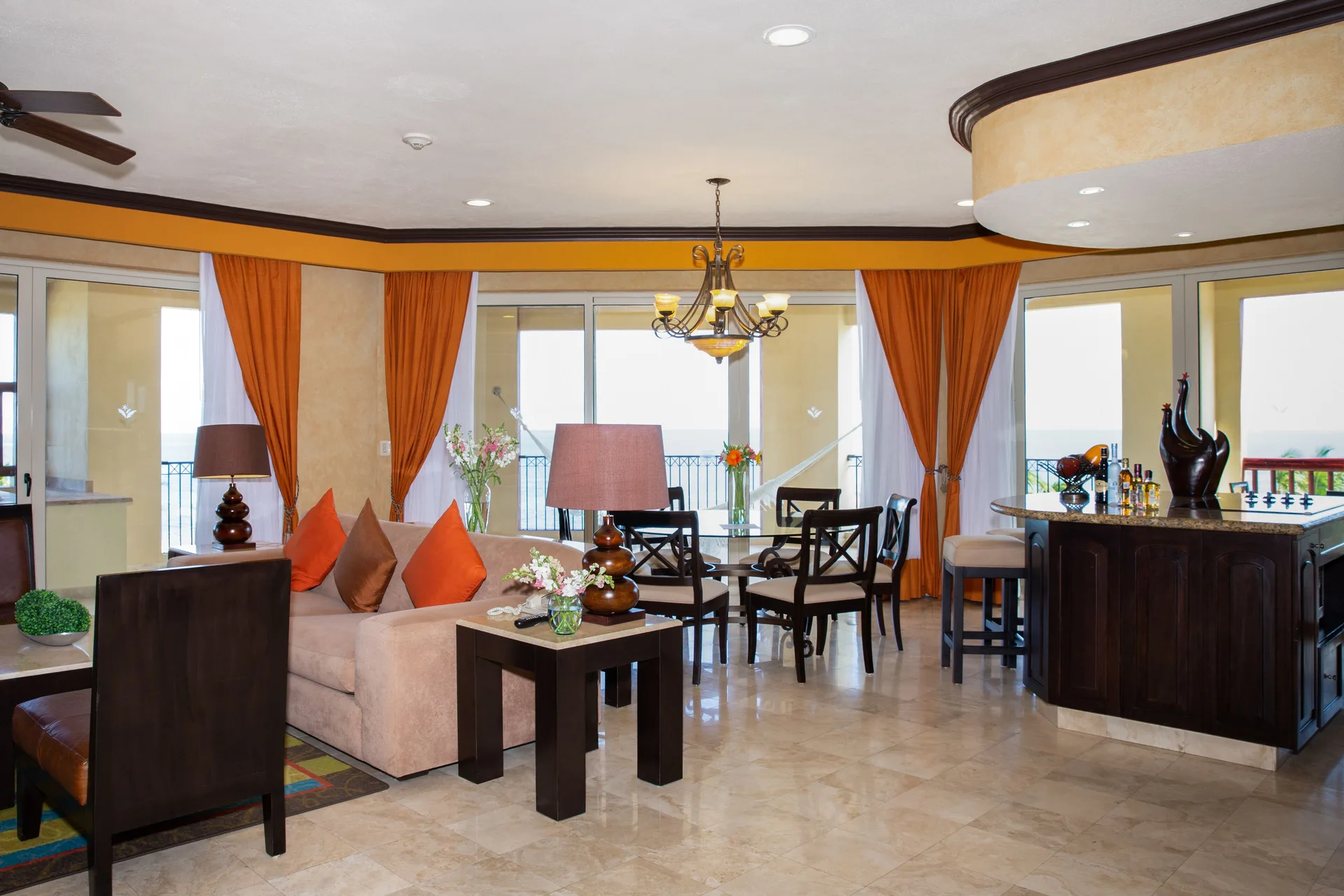 Living and dining area with wet bar at Villa del Palmar Cancun Beach Resort & Spa.