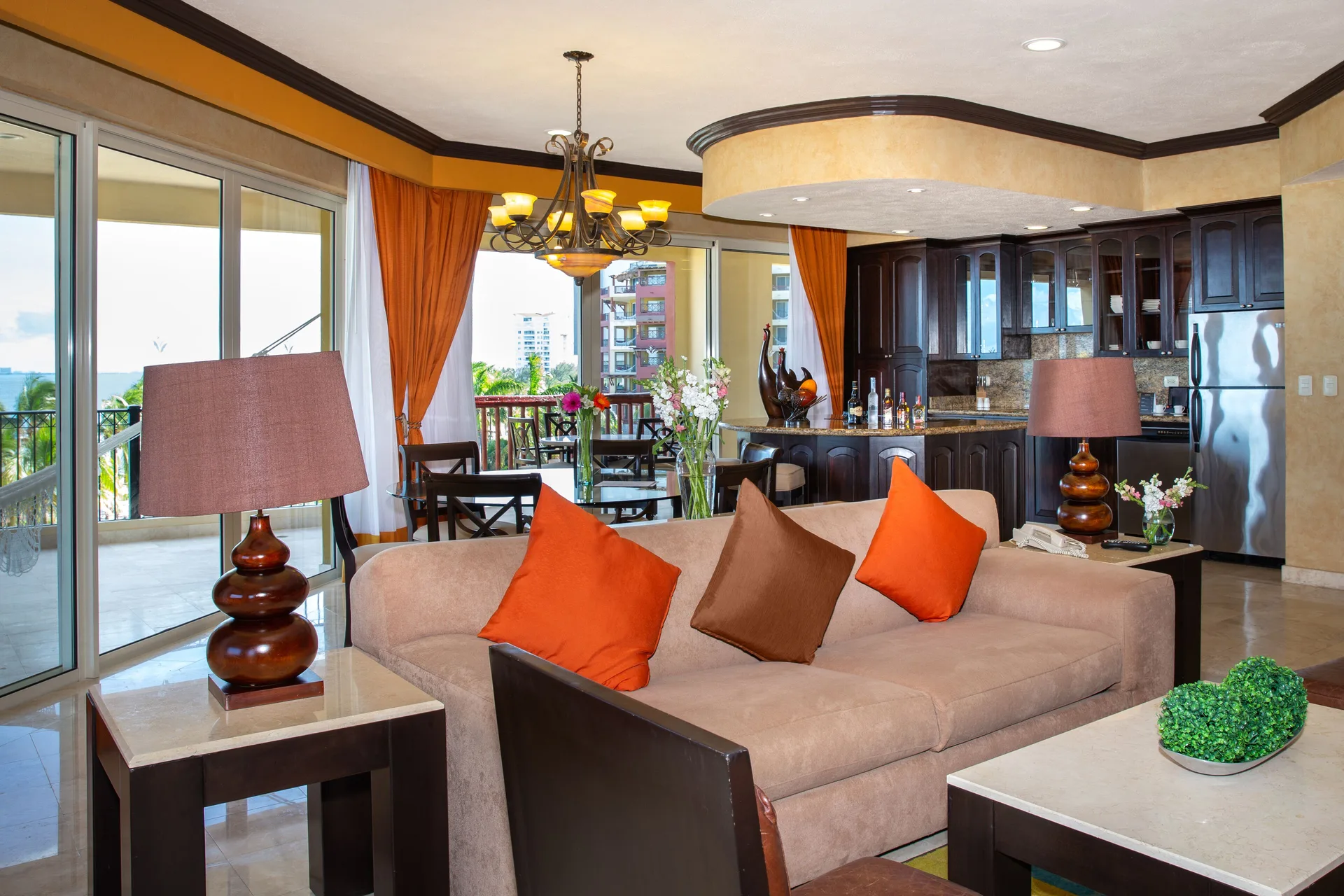 Suite lounge with kitchen and balcony doors at Villa del Palmar Cancun Beach Resort & Spa.