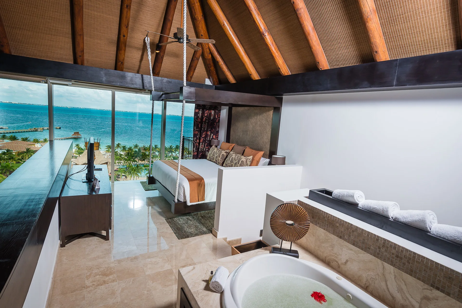 Two Bedroom Loft upper bedroom with king bed, soaking tub, and ocean view at Villa del Palmar Cancun Beach Resort & Spa.