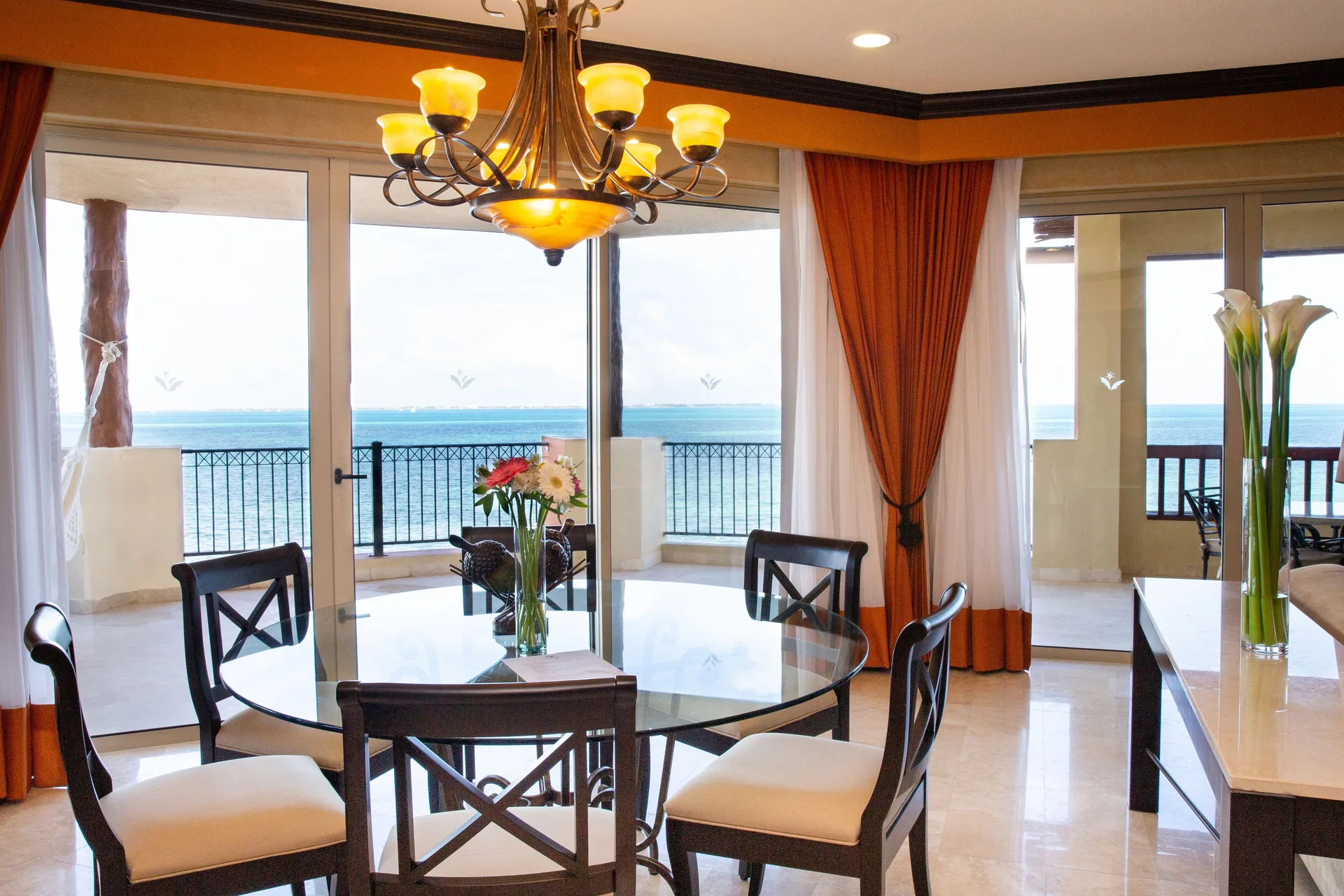 Two Bedroom Ocean Front dining table with ocean balcony view at Villa del Palmar Cancun Beach Resort & Spa.