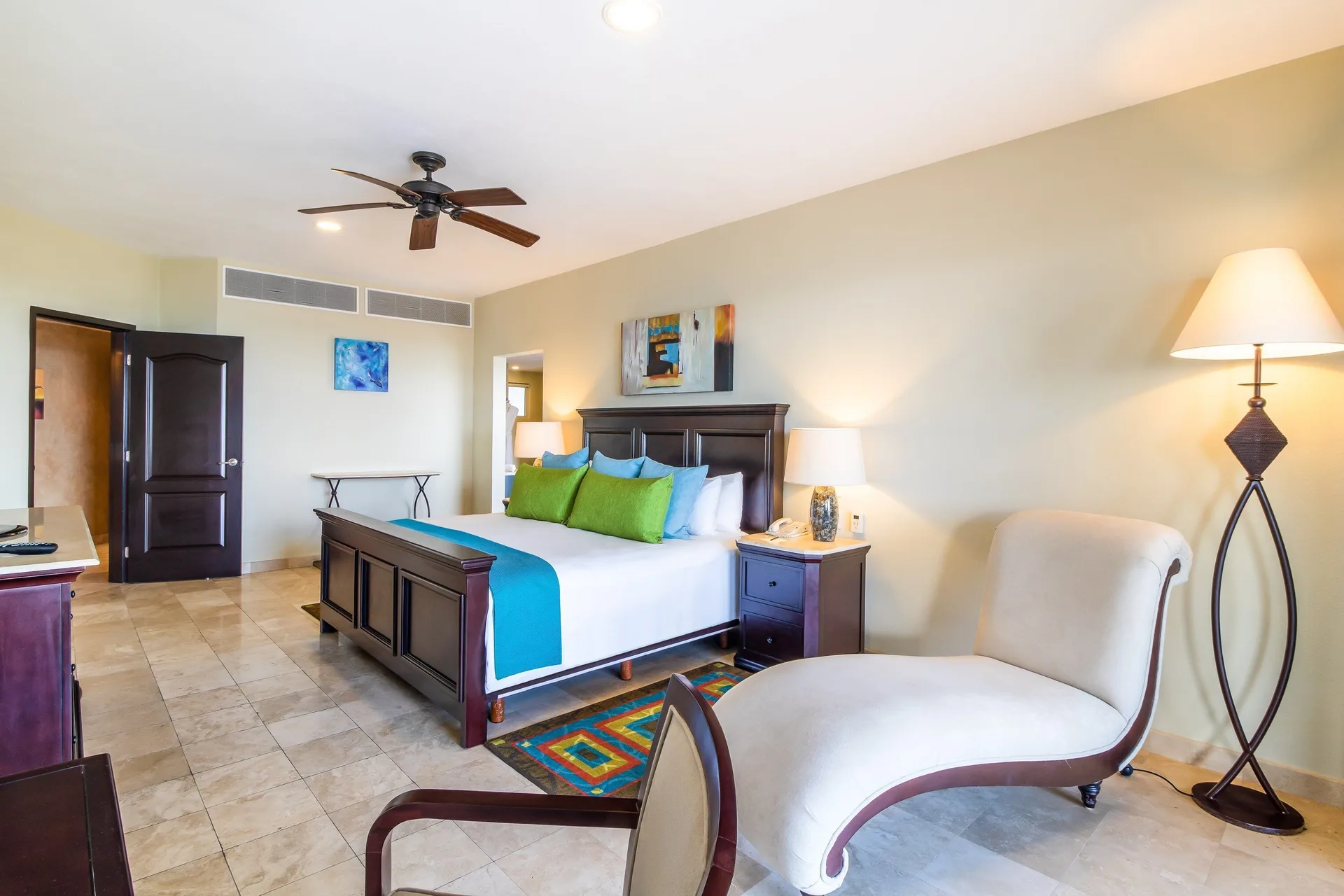 Two Bedroom Ocean Front bedroom with king bed and chaise at Villa del Palmar Cancun Beach Resort & Spa.