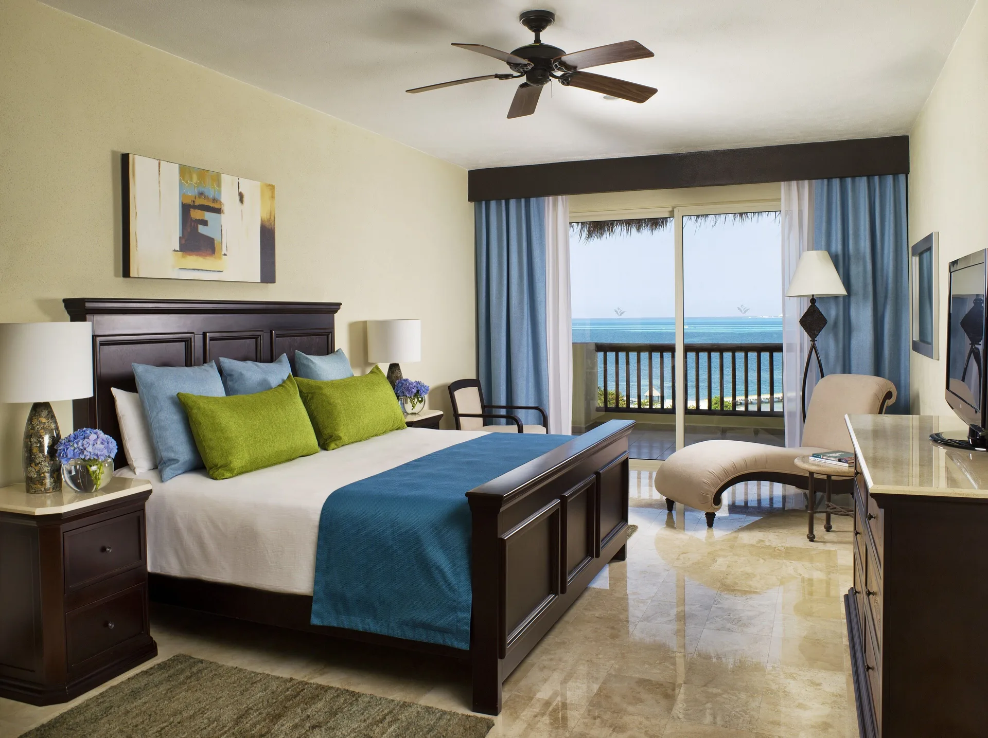 Two Bedroom Ocean Front king bedroom with ocean-facing balcony at Villa del Palmar Cancun Beach Resort & Spa.