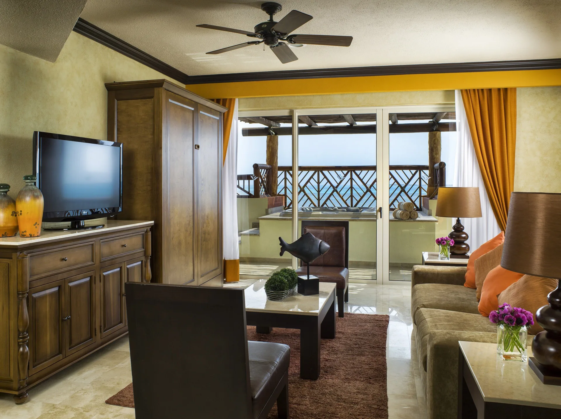 Two Bedroom Ocean Front living room with balcony doors at Villa del Palmar Cancun Beach Resort & Spa.
