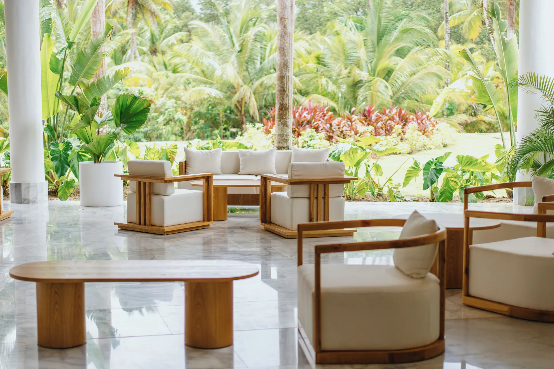 Lobby seating area opening to lush tropical gardens at Viva Miches.